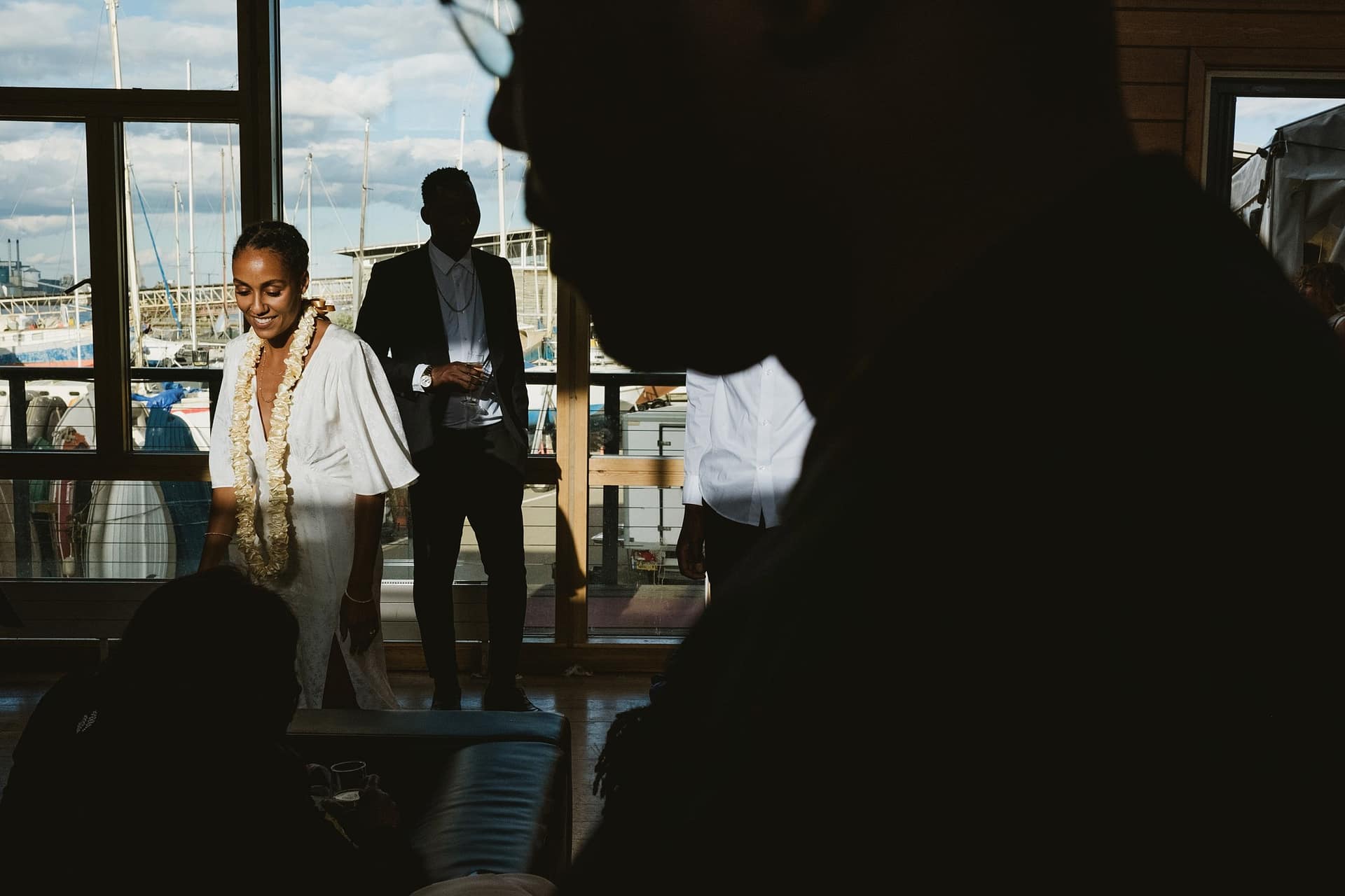 A stunning Greenwich Yacht Club wedding, capturing the beautiful bond between a bride and groom as they stand in front of a window.