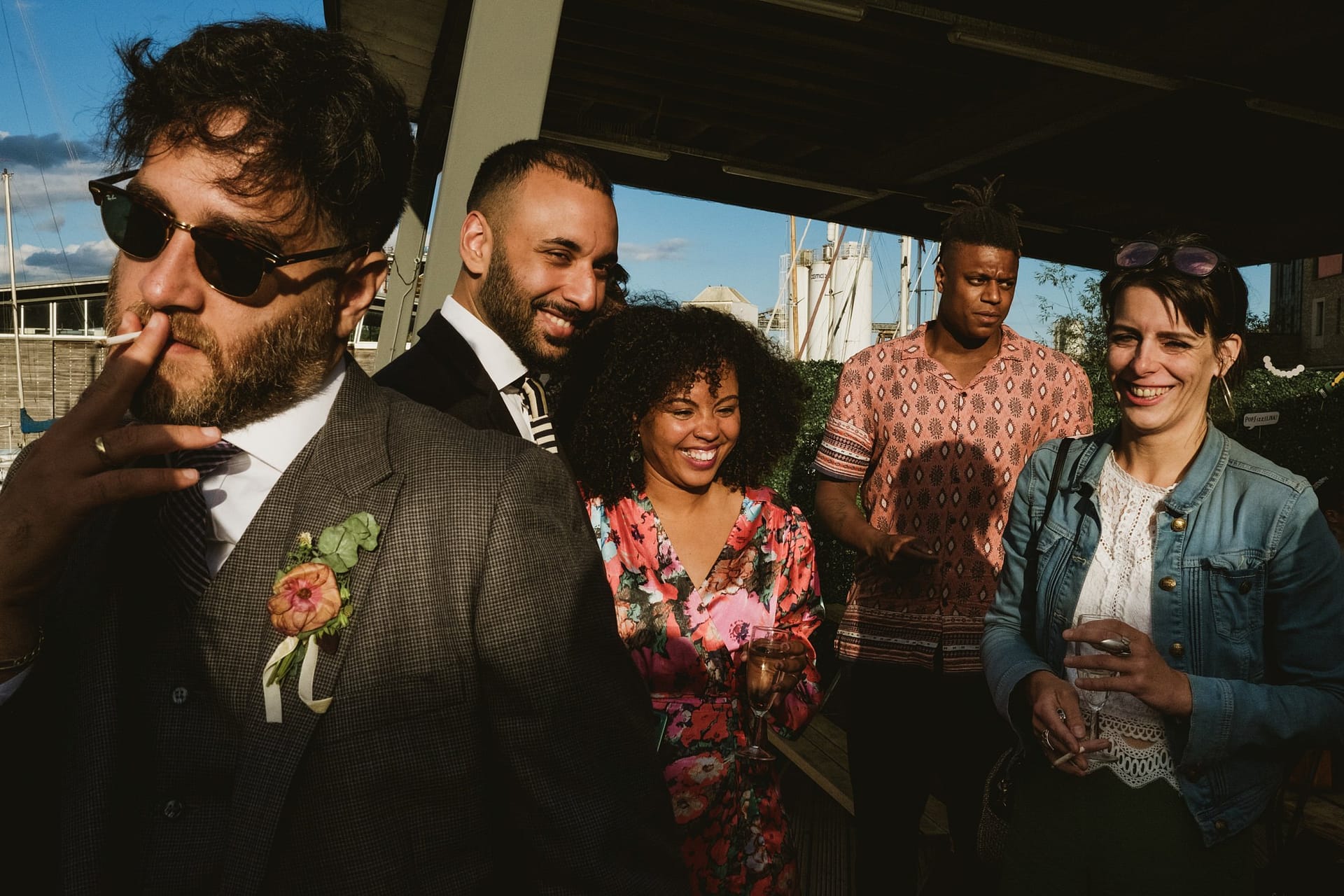 A group of people with sunglasses enjoying a Greenwich Yacht Club wedding, captured beautifully through photography.