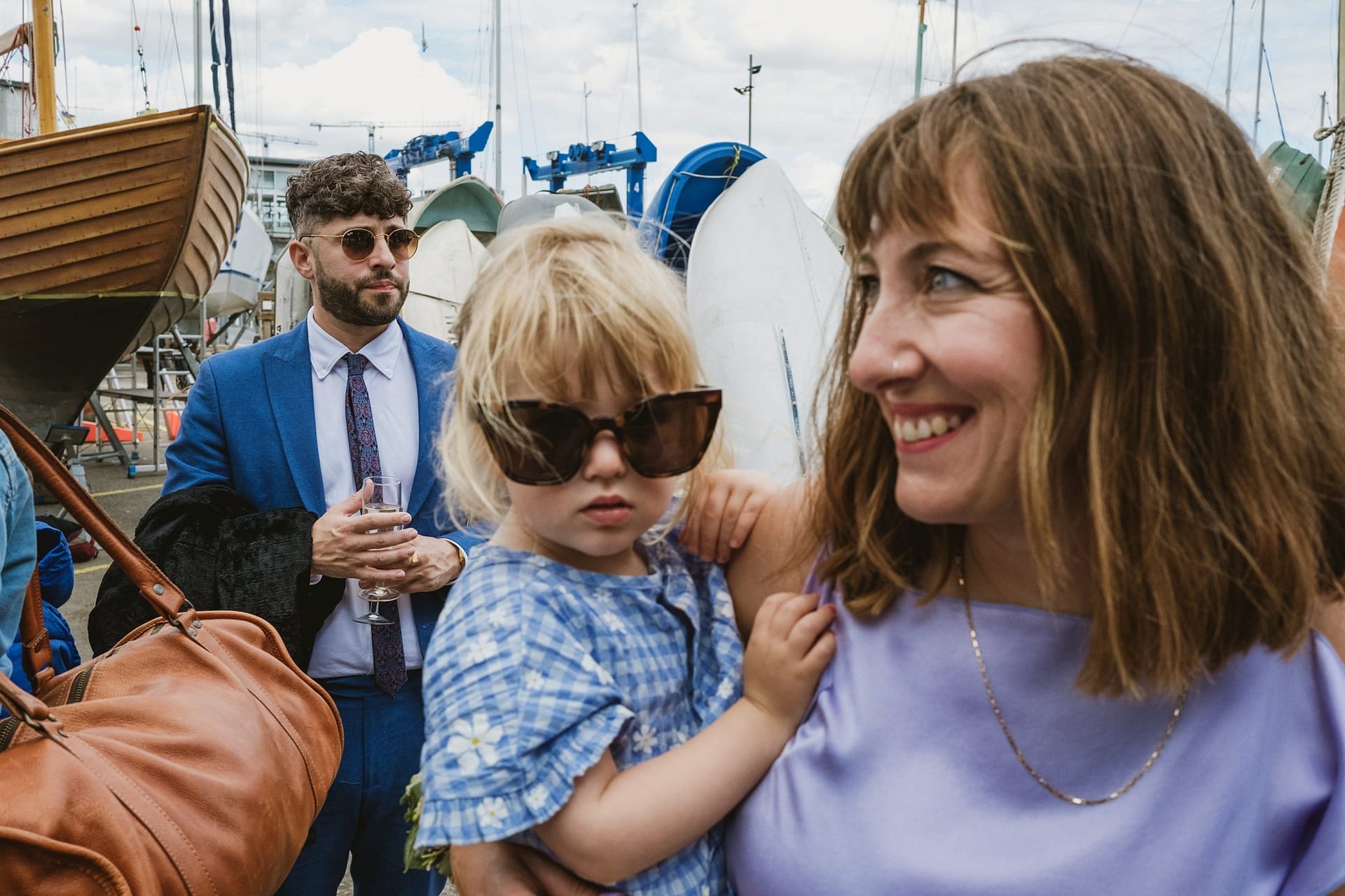 A woman with a young child in front of a boat at Greenwich Yacht Club.