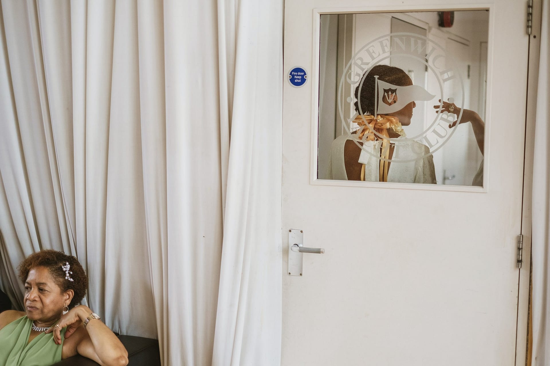 A woman admiring her reflection in a mirror at the Greenwich Yacht Club.