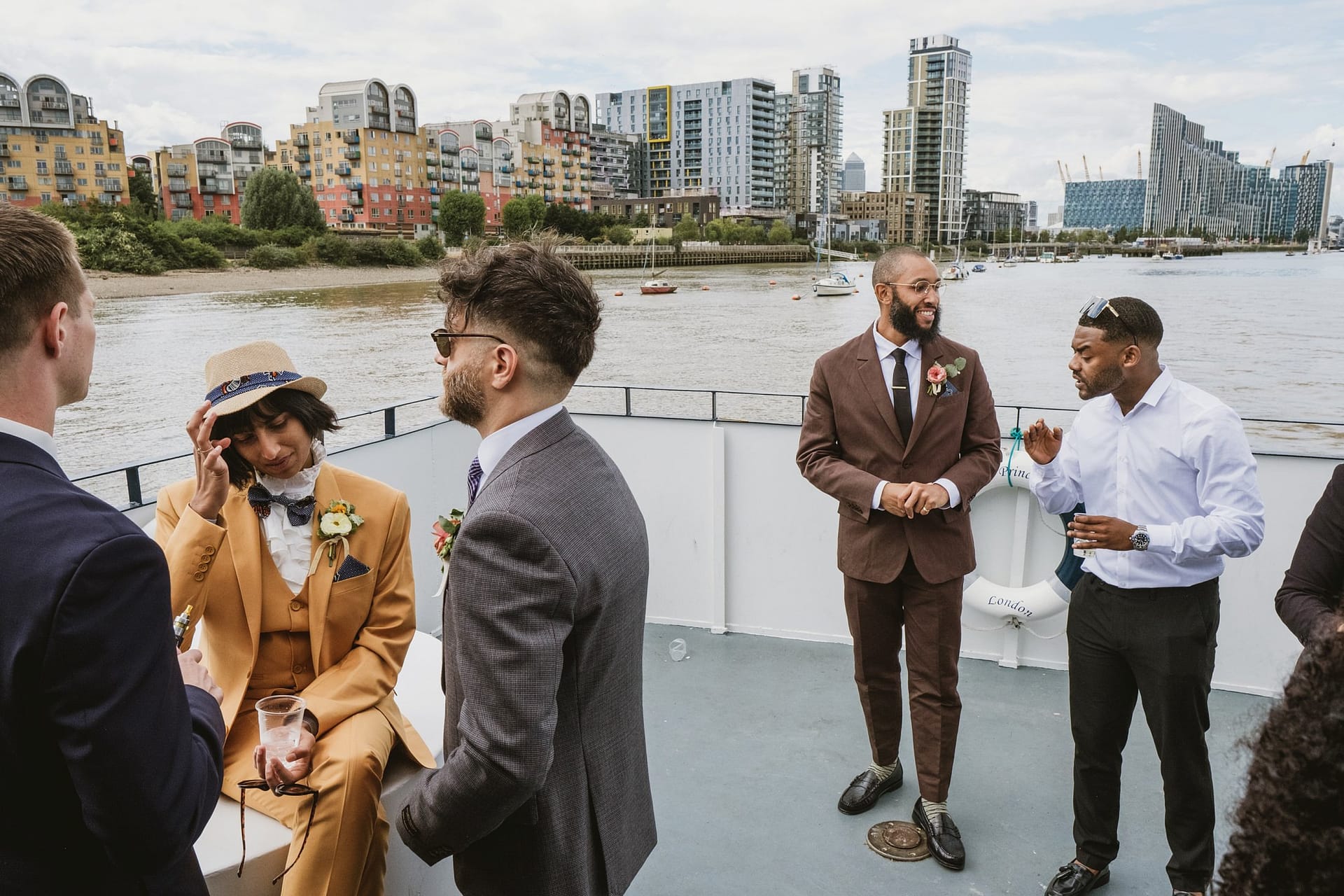 A group of wedding guests at the Greenwich Yacht Club, talking to each other during a wedding reception.
