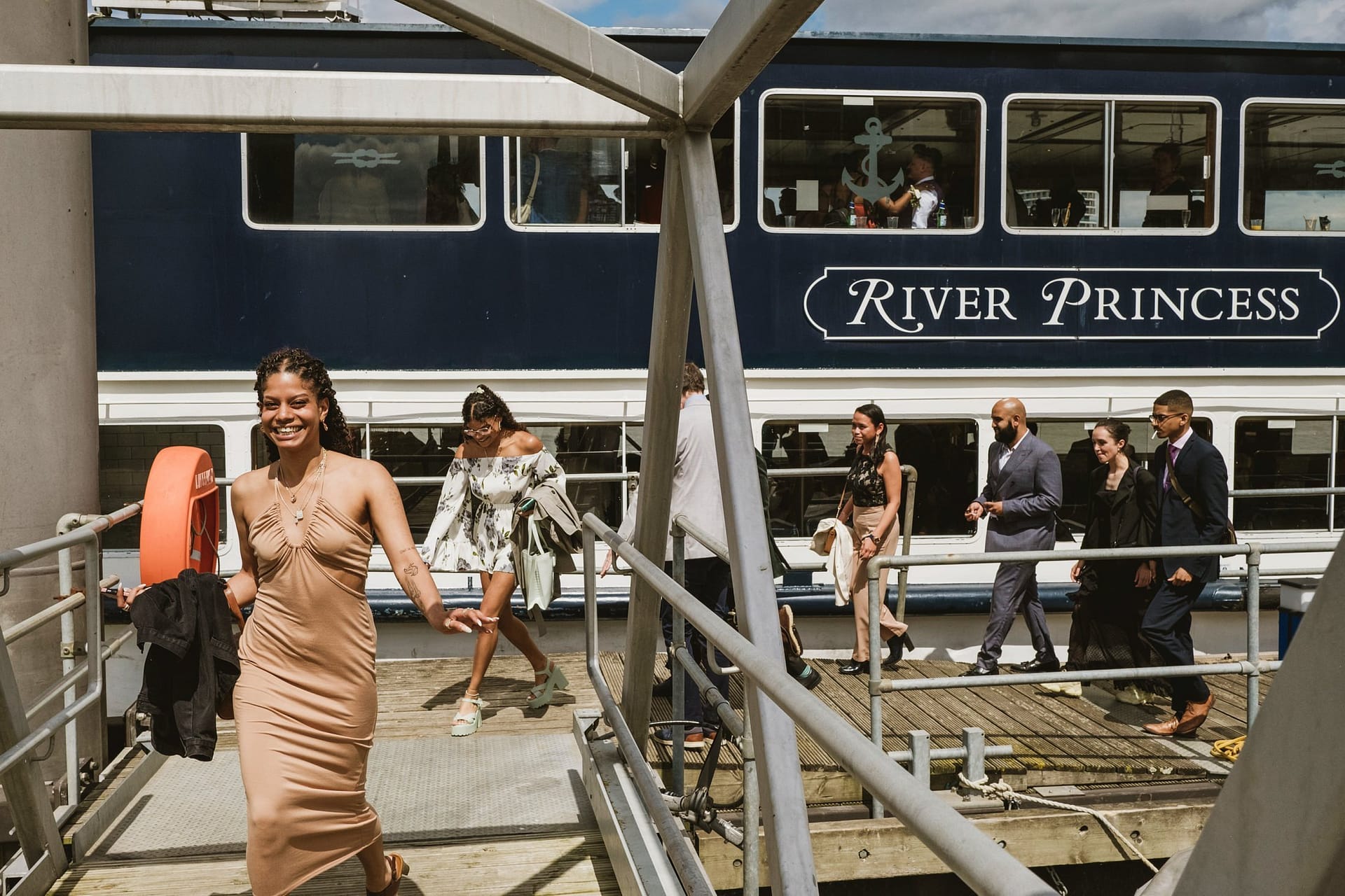 Greenwich Yacht Club Wedding Photography captures a stunning moment of a bride and groom on the steps of a beautiful boat.