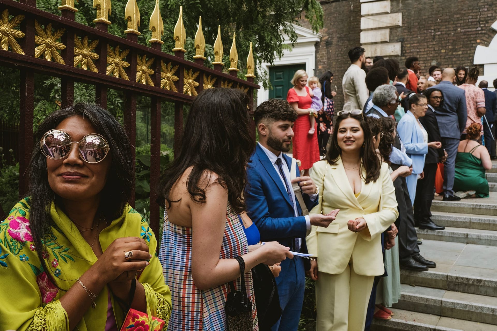 Greenwich Yacht Club Wedding Photography - A group of people standing on the steps of a building.