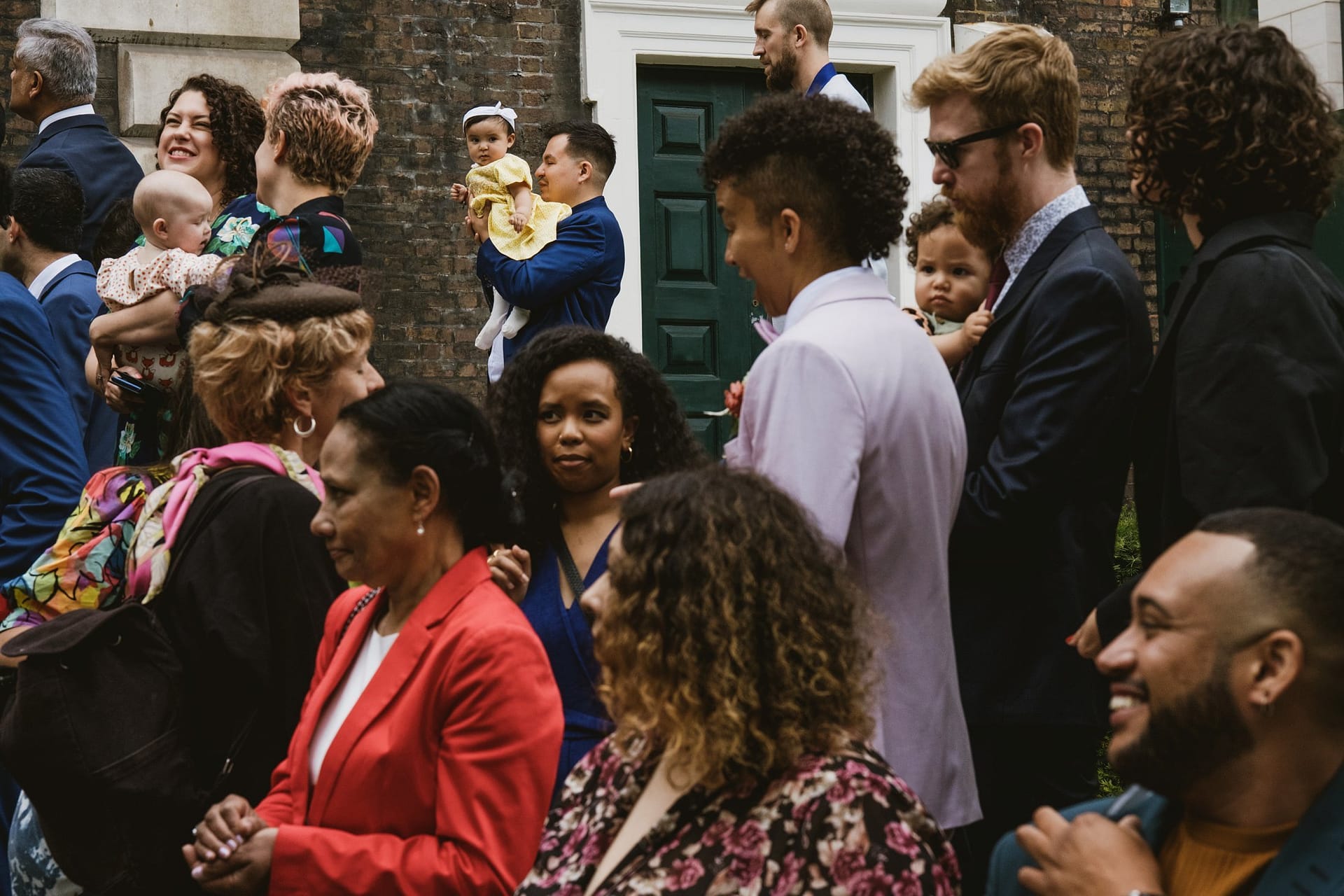 A group of people standing in front of the church in London