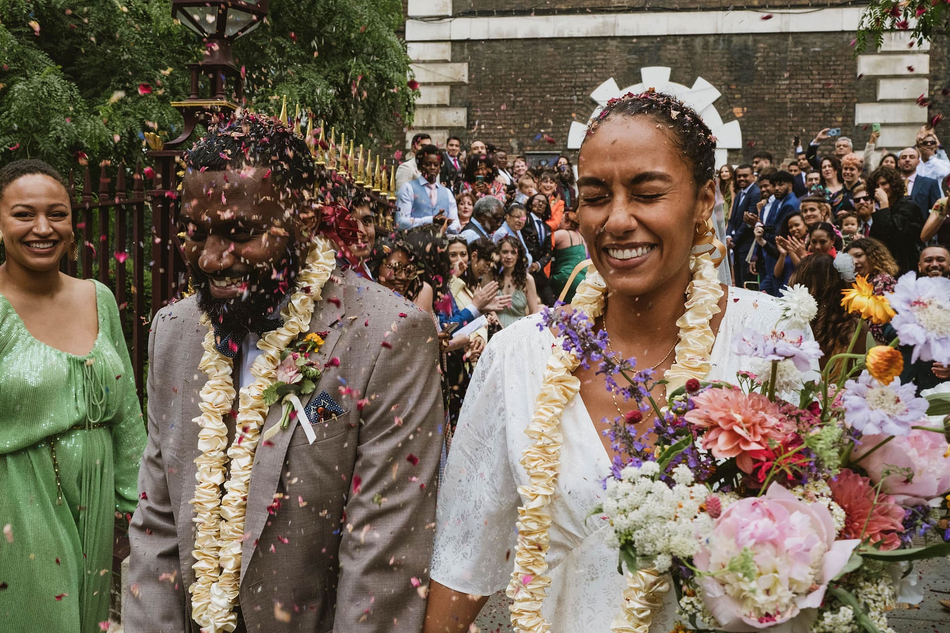 A bride and groom walk down the aisle at their Greenwich Yacht Club wedding, with confetti thrown at them.