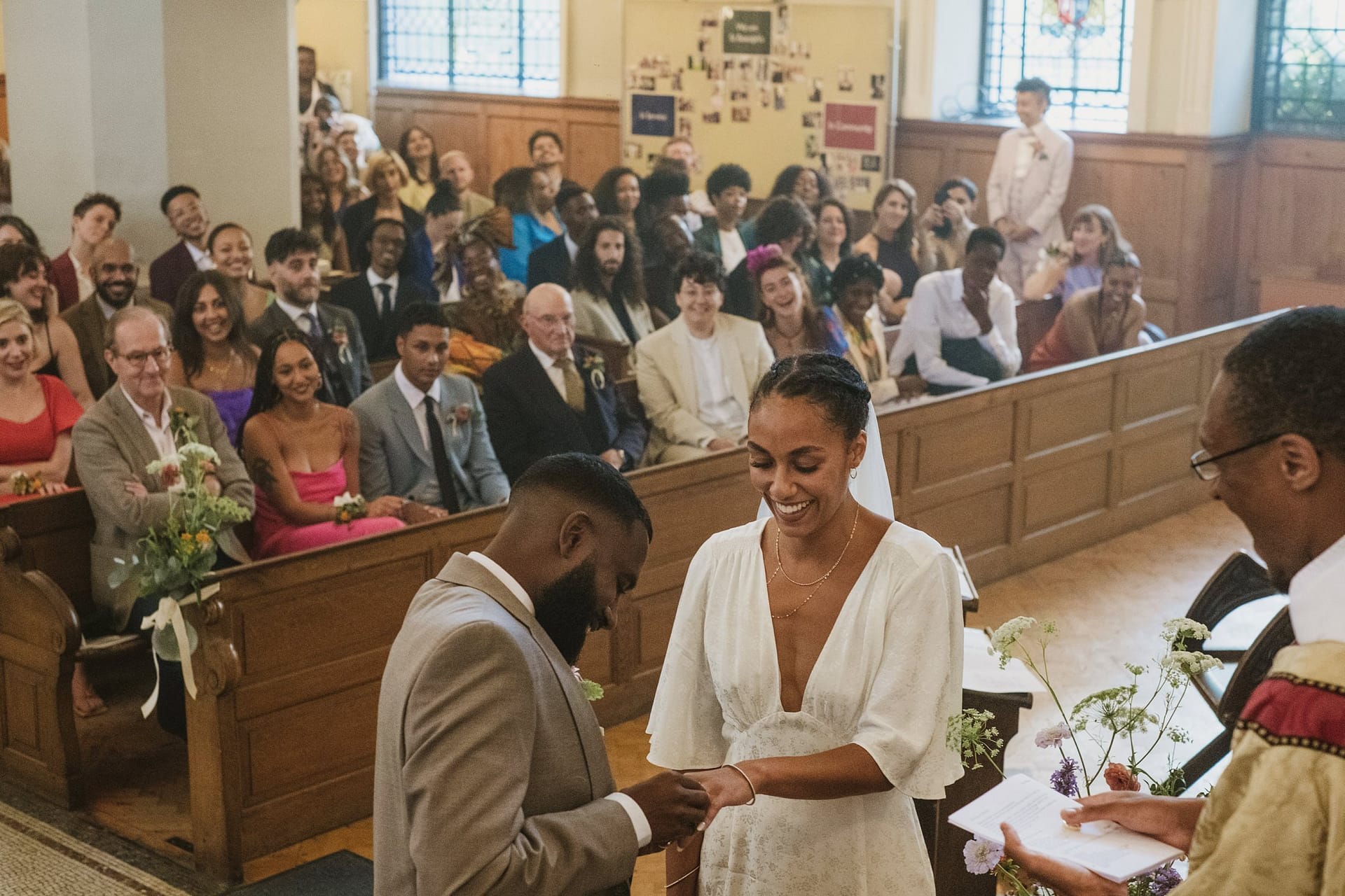 A bride and groom exchanging their vows in a church during their Greenwich Yacht Club wedding.