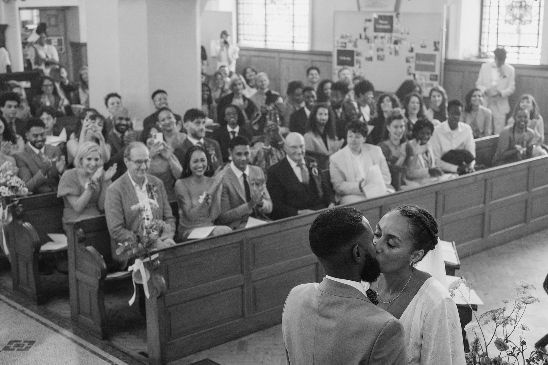 A bride and groom share a romantic kiss during their Greenwich Yacht Club wedding ceremony.