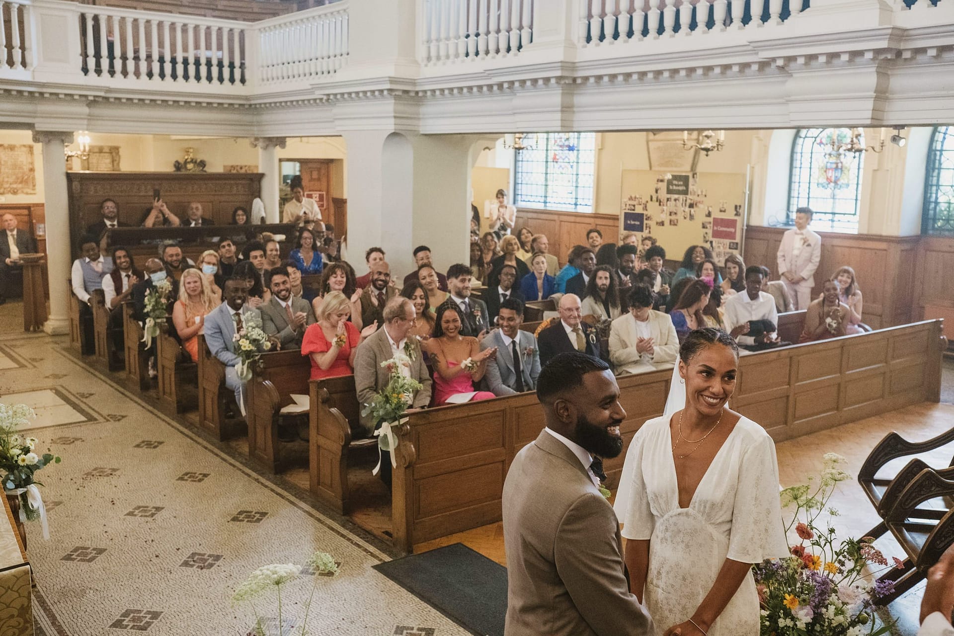 A man and woman exchanging vows at a beautiful church during their Greenwich Yacht Club Wedding. The photographer captures the heartfelt moments of joy and love as they stand together, surrounded by the elegant surroundings