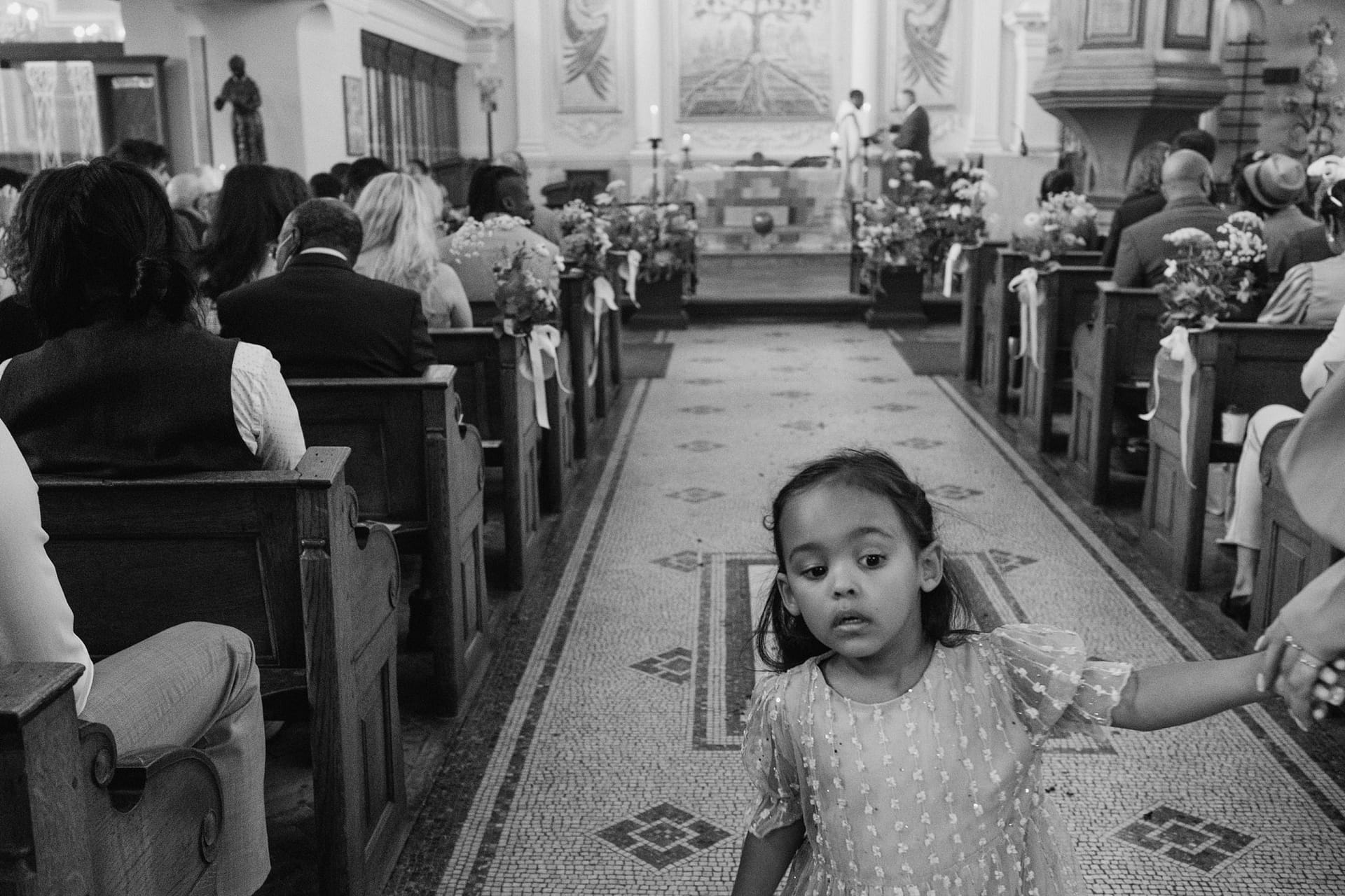 A little girl walking down the aisle at a Greenwich Yacht Club wedding.