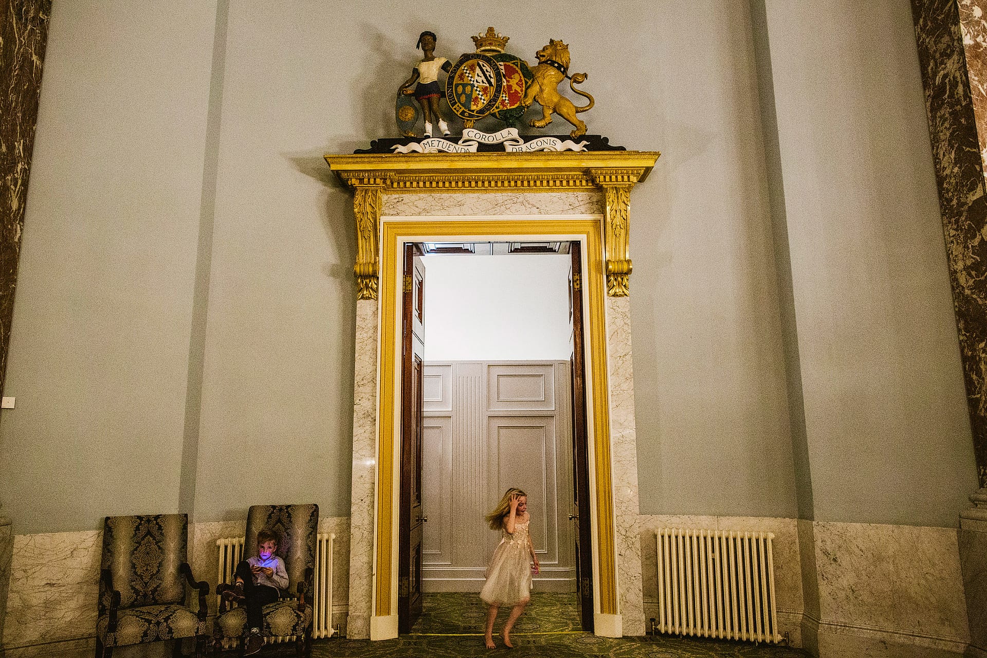 Child caught in motion running through the doorway at the historic Wynyard Hall