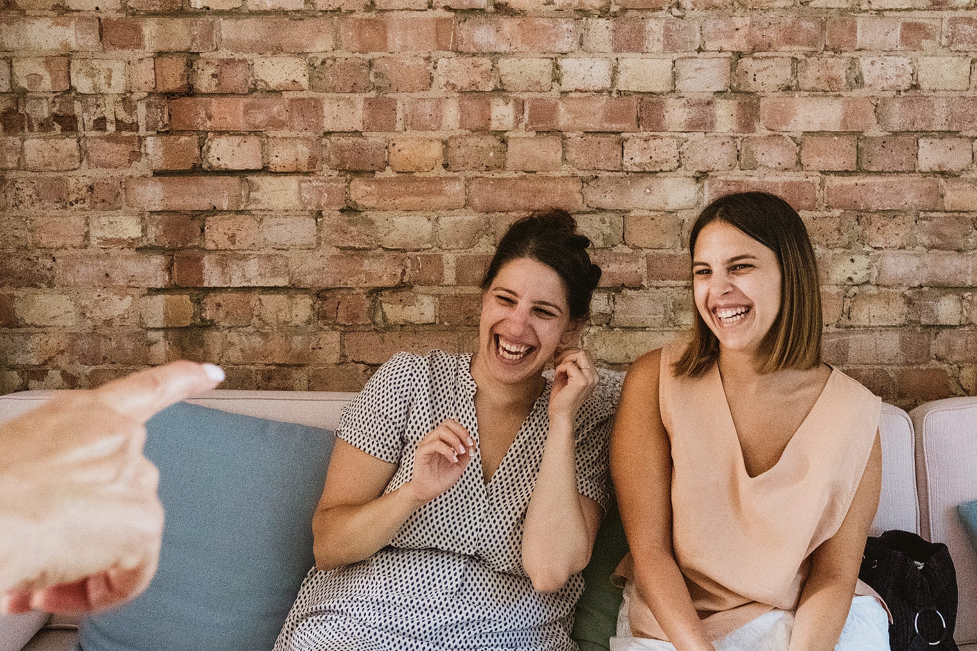 Bride and bridesmaid laughing