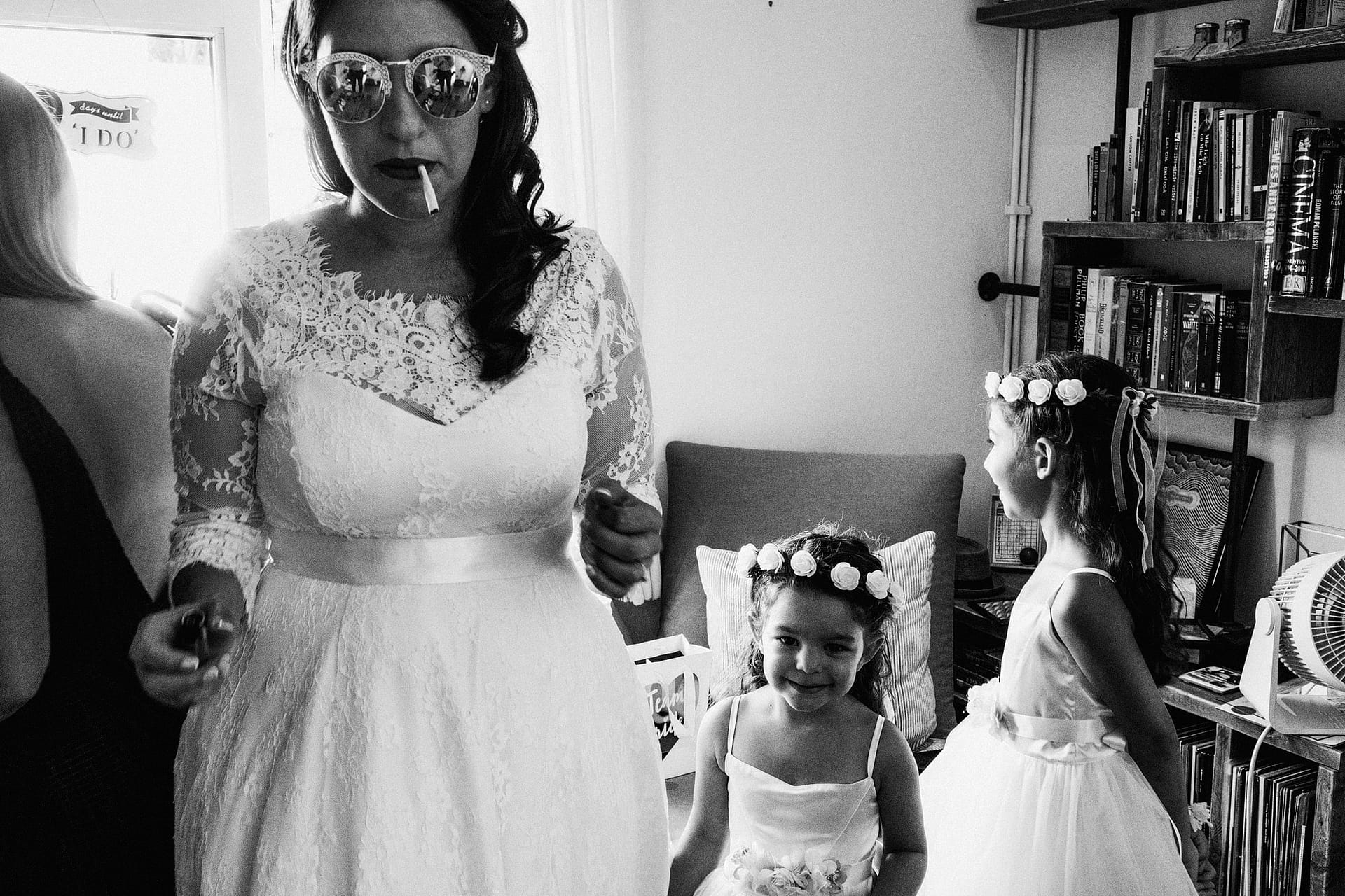 Bride with sunglasses and flower girls