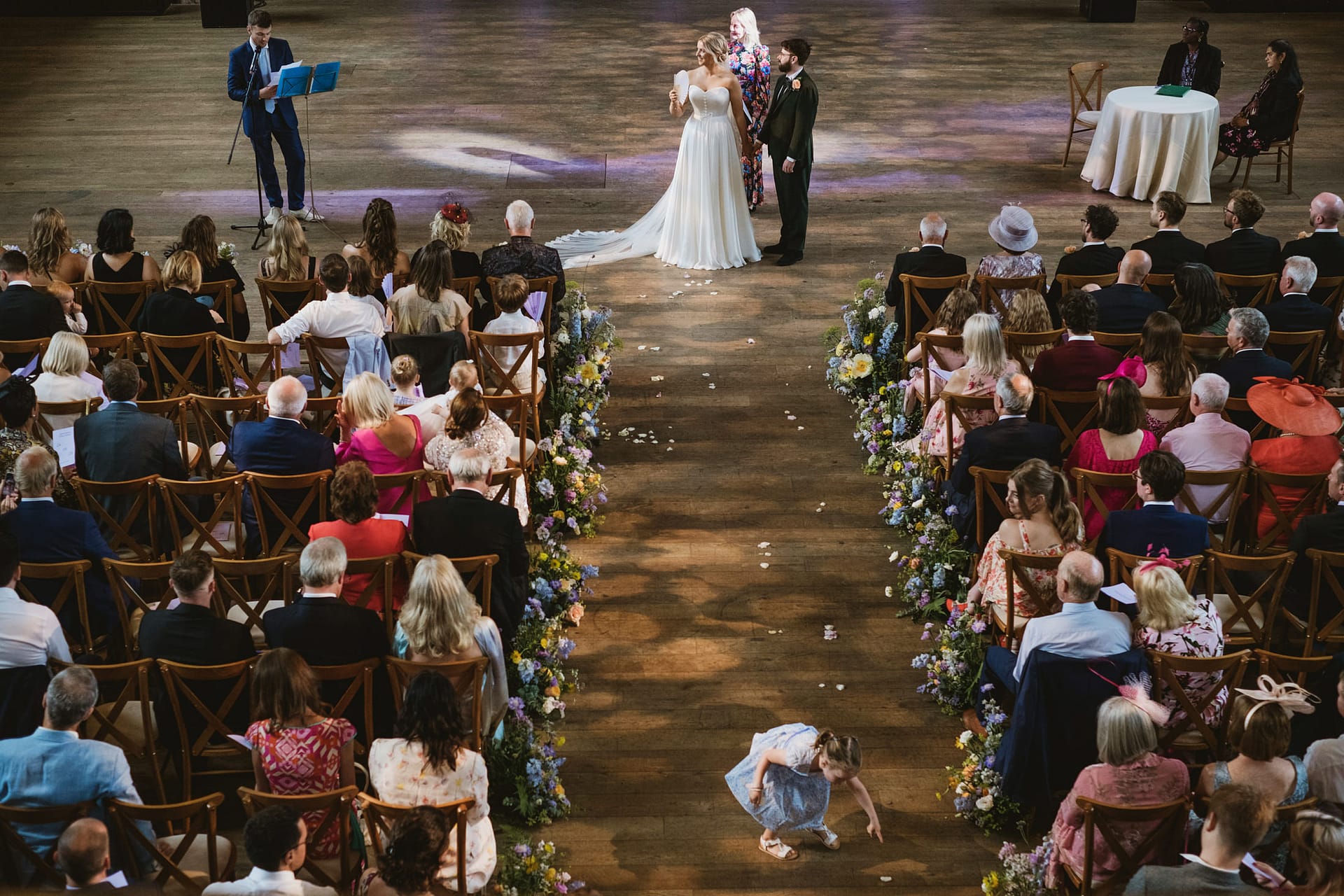 Wedding ceremony with guests and flower decorations.