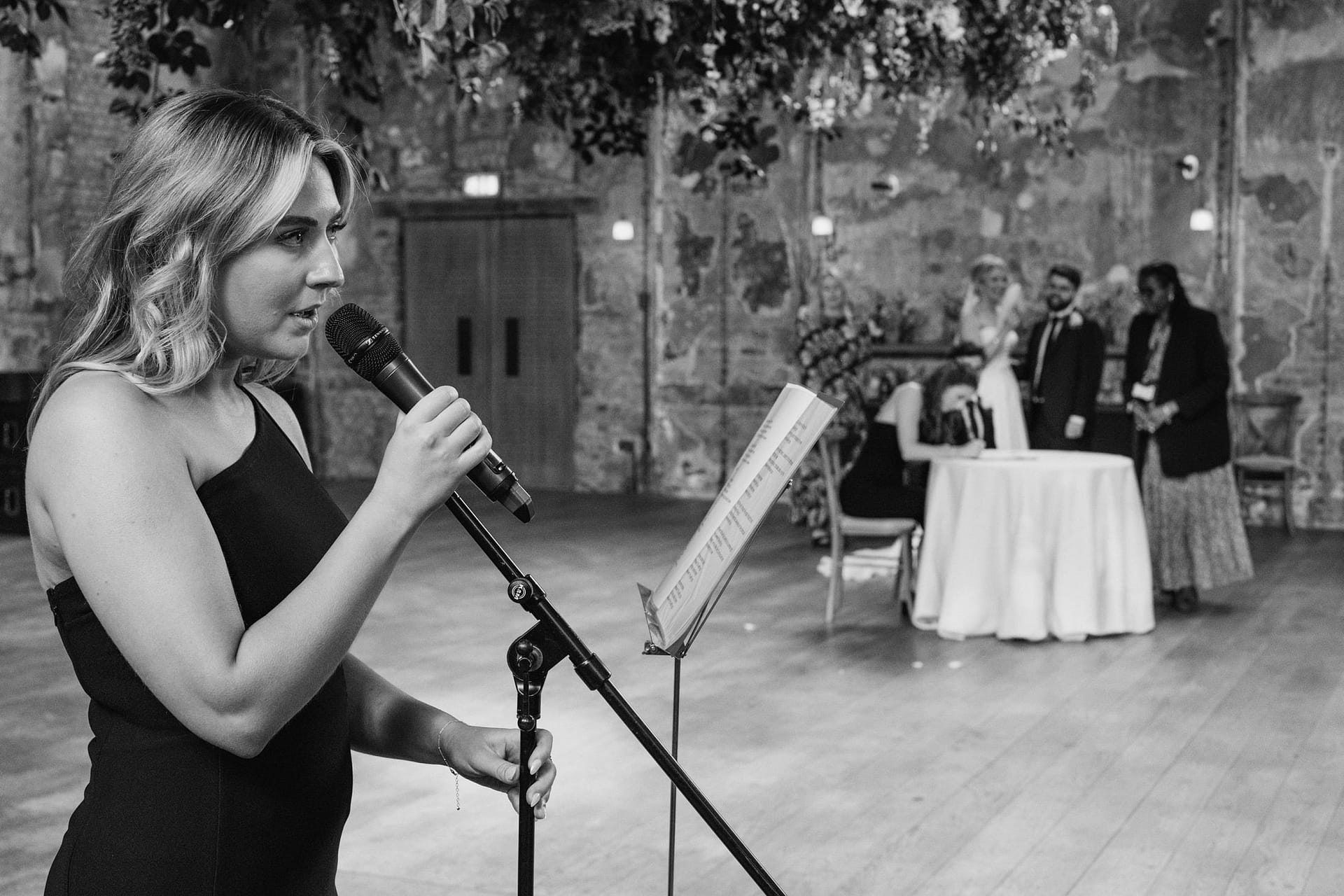 Woman singing at wedding ceremony.