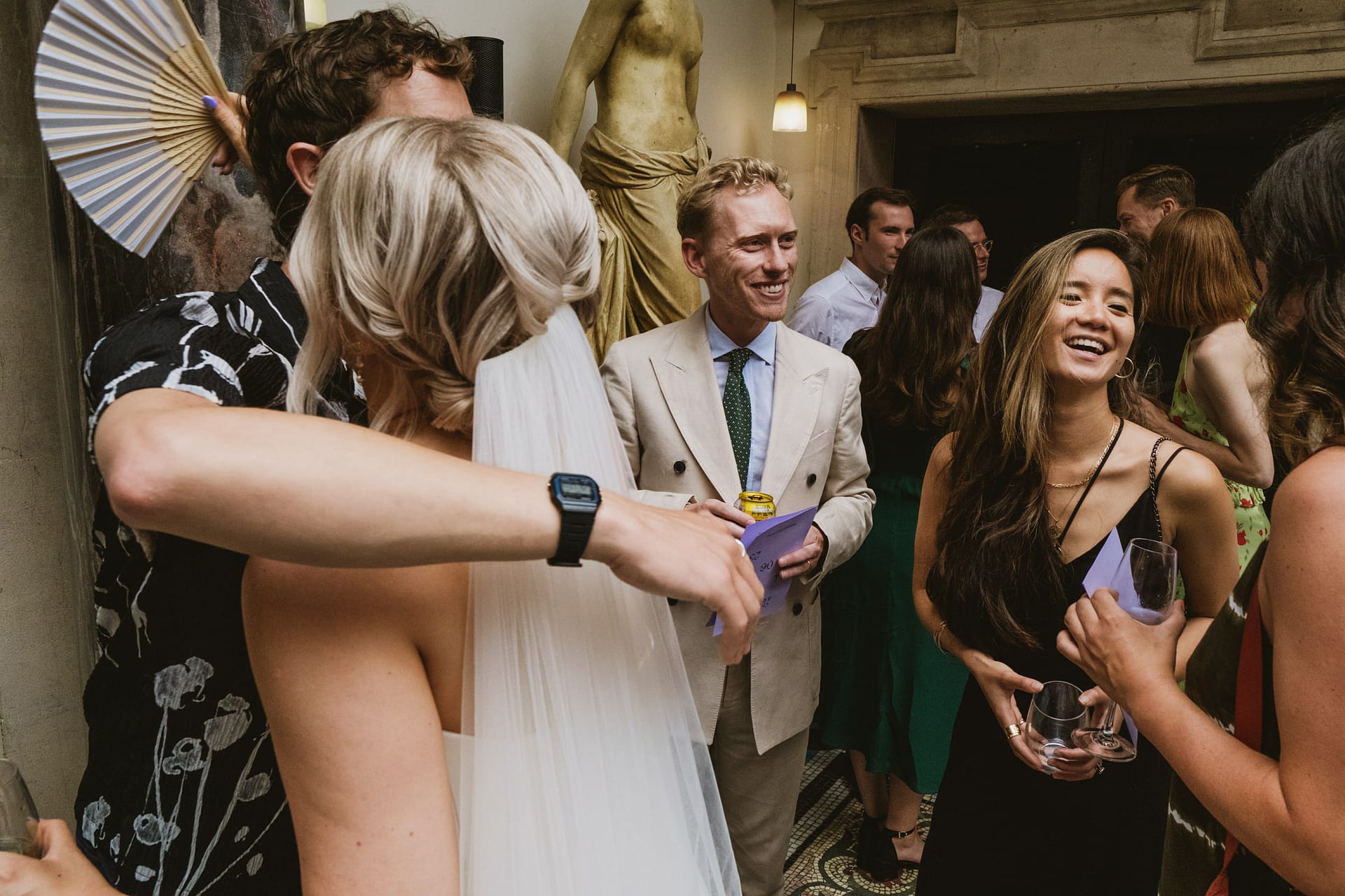 People celebrating at a wedding reception indoors.