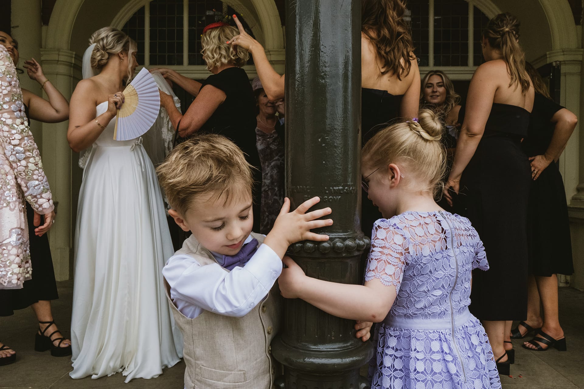 Children playing near adults at an event.