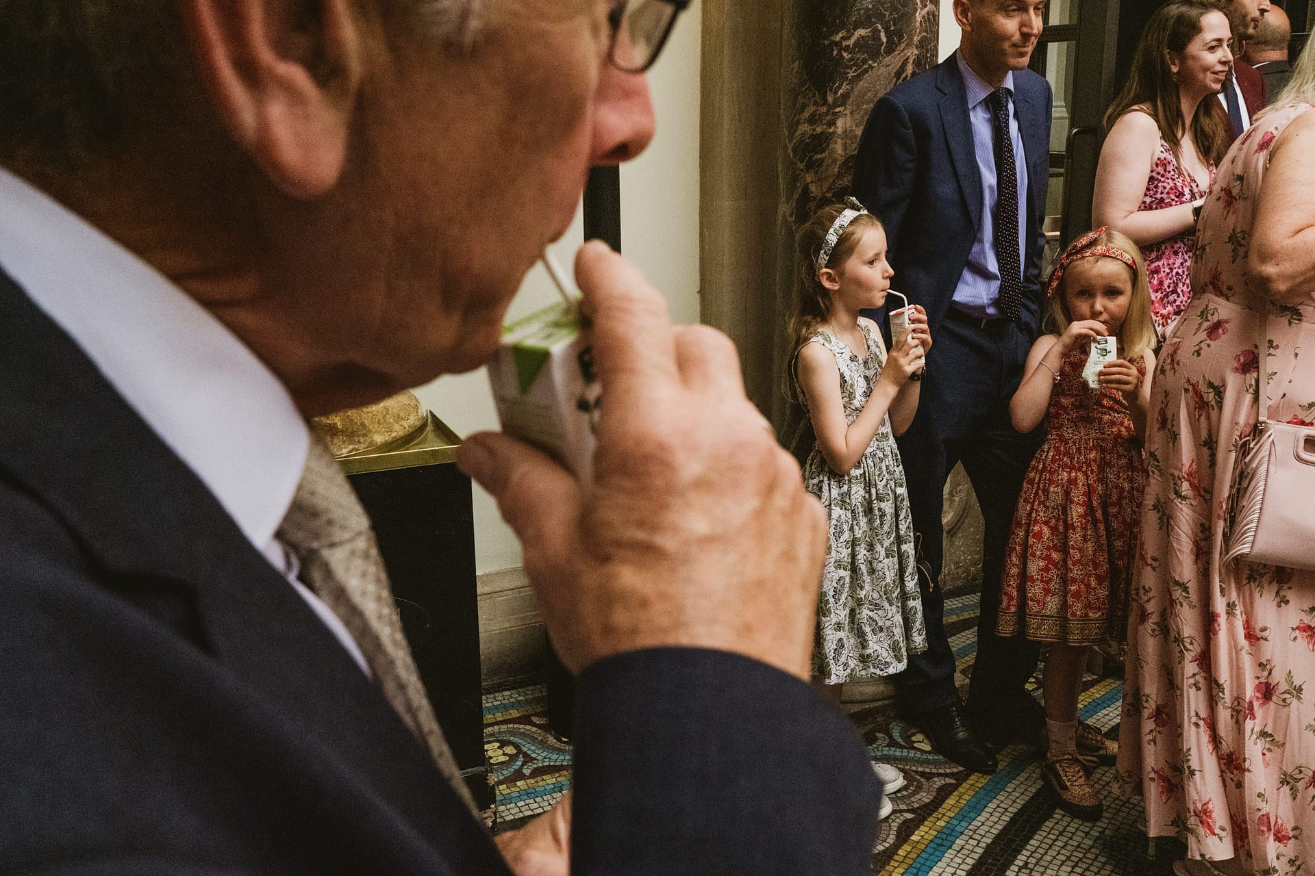 People at an event drinking from cartons.