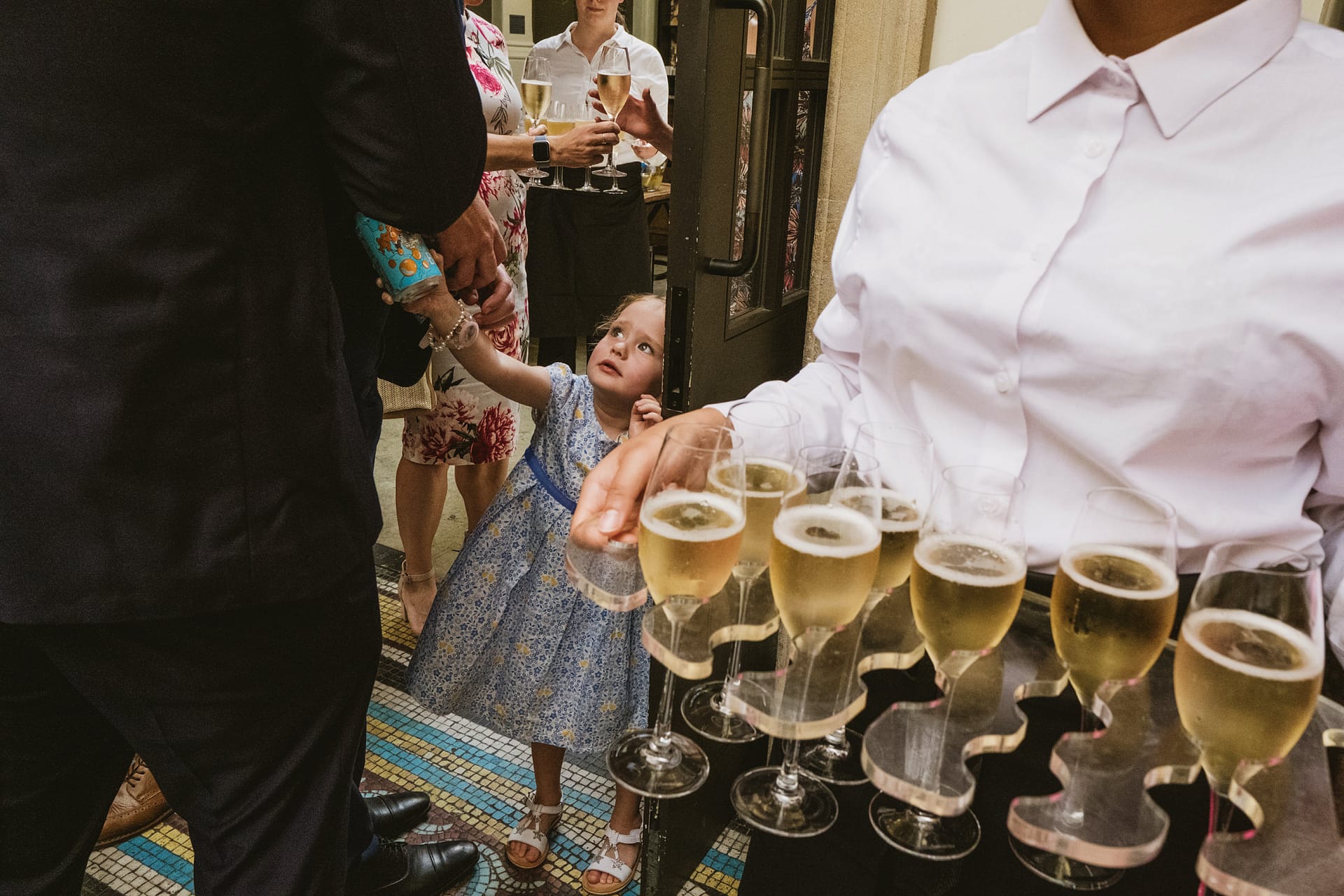 Waiter serving champagne at elegant reception.