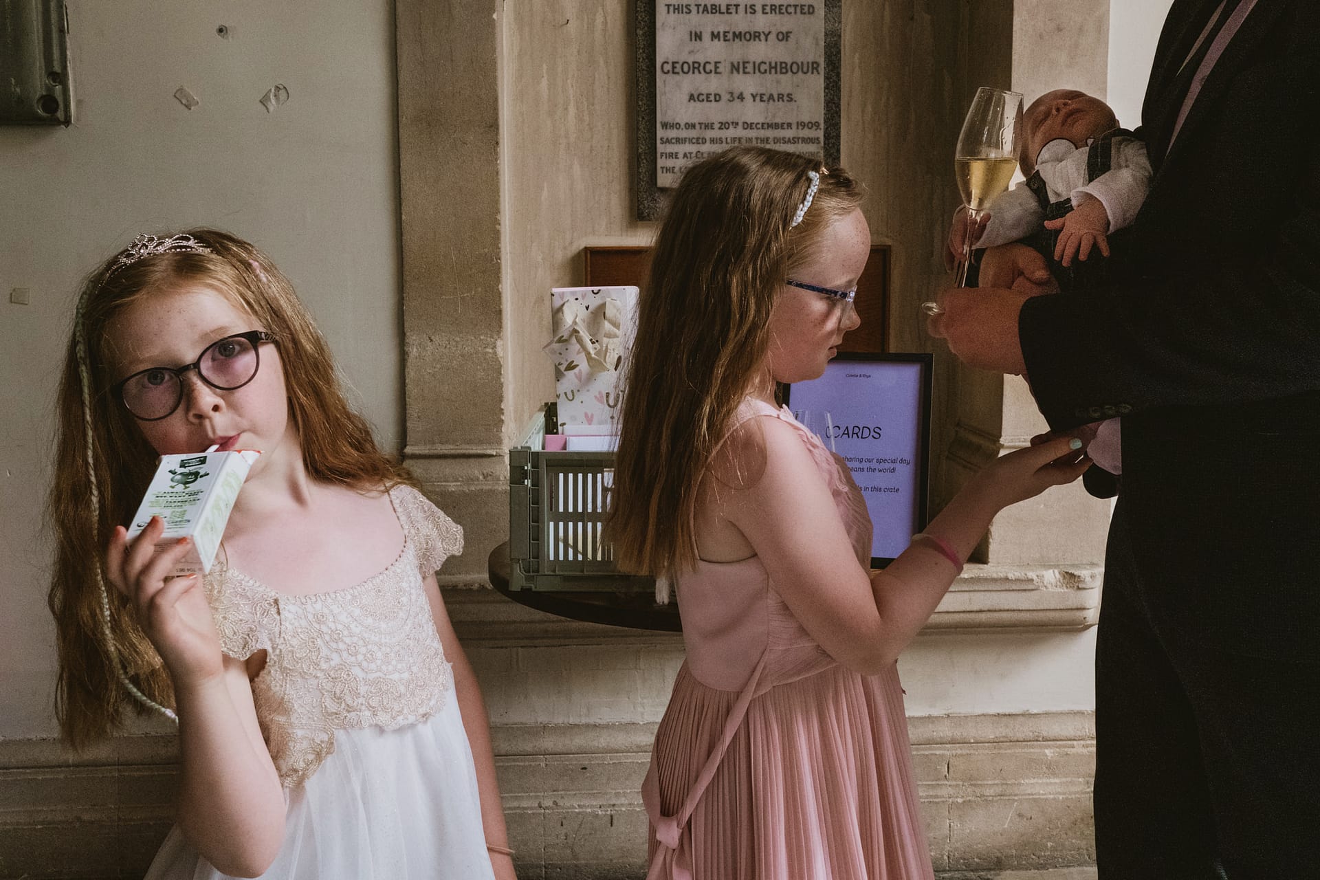 Children at a wedding with drinks and baby.