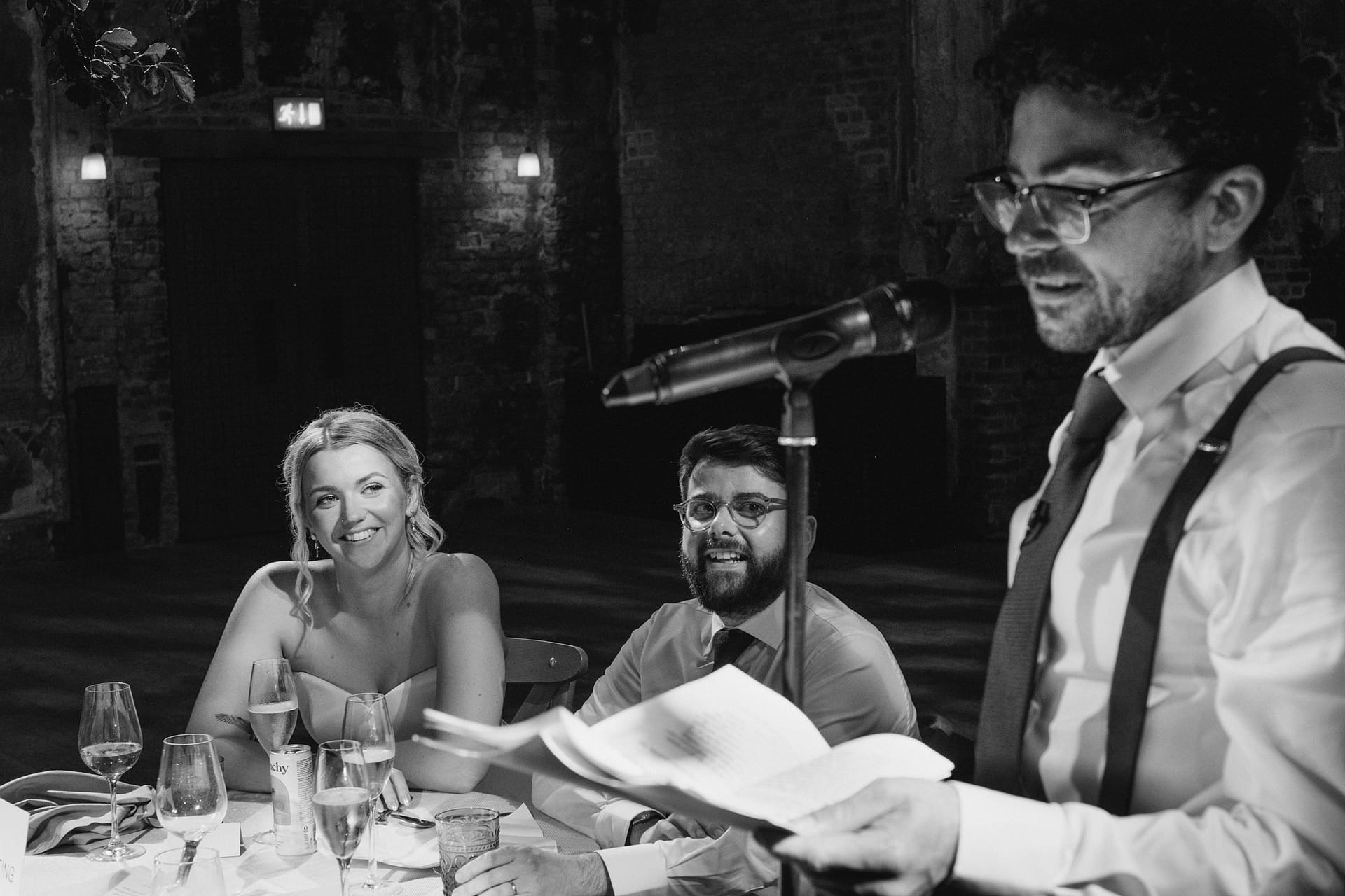 Best man giving speech at wedding reception.