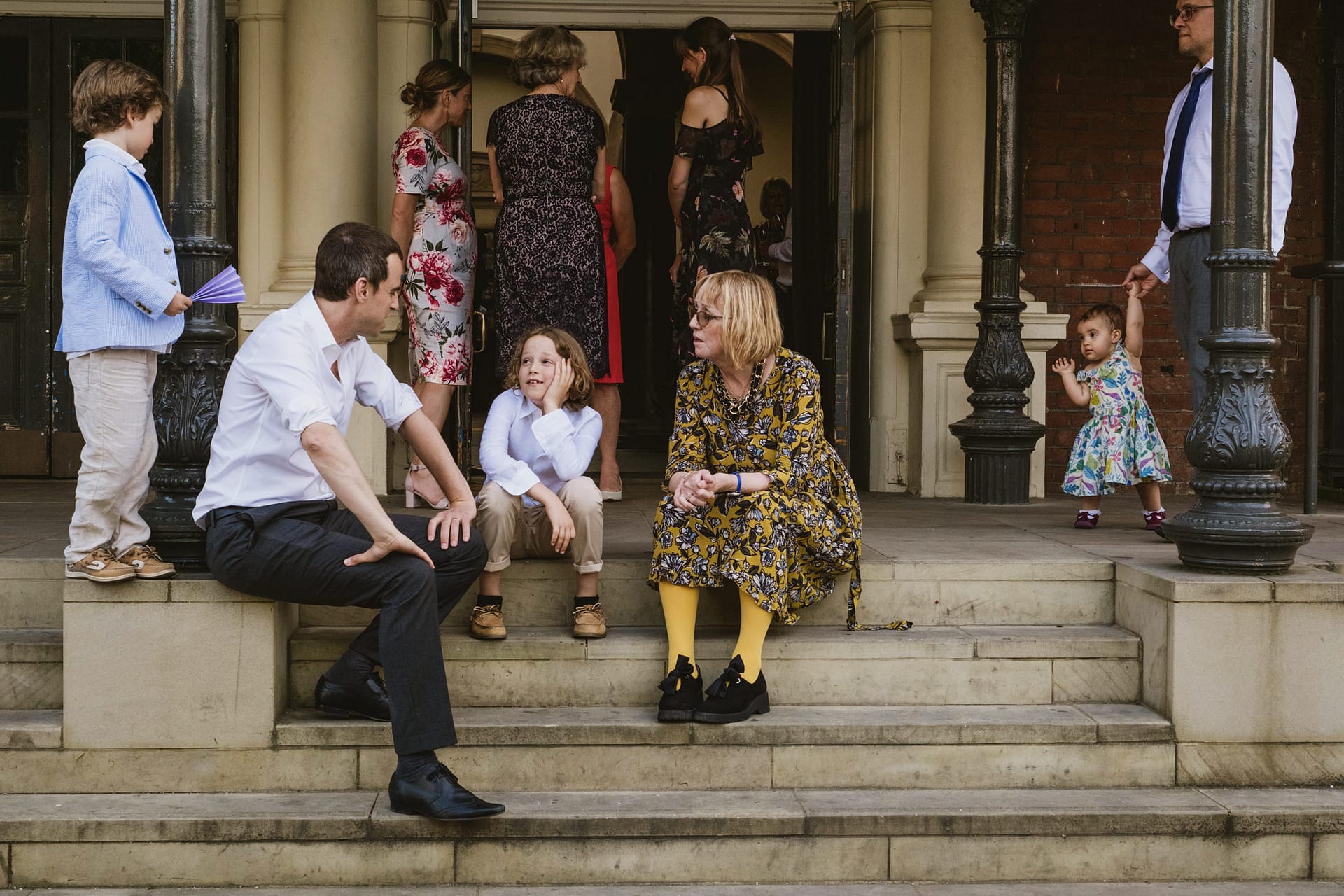 People socialising on steps outside a building