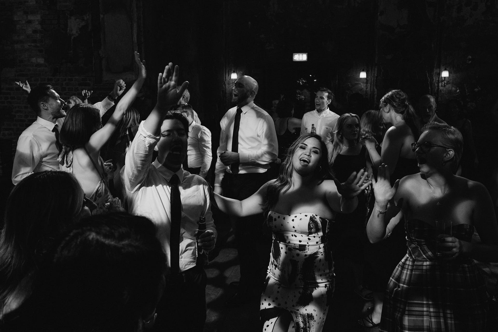 People dancing joyfully at a lively indoor party.