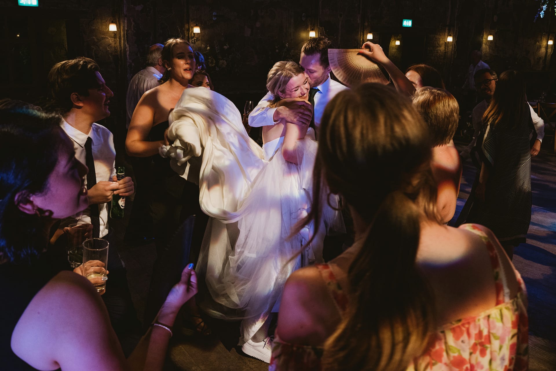Wedding guests dancing and celebrating joyfully together.