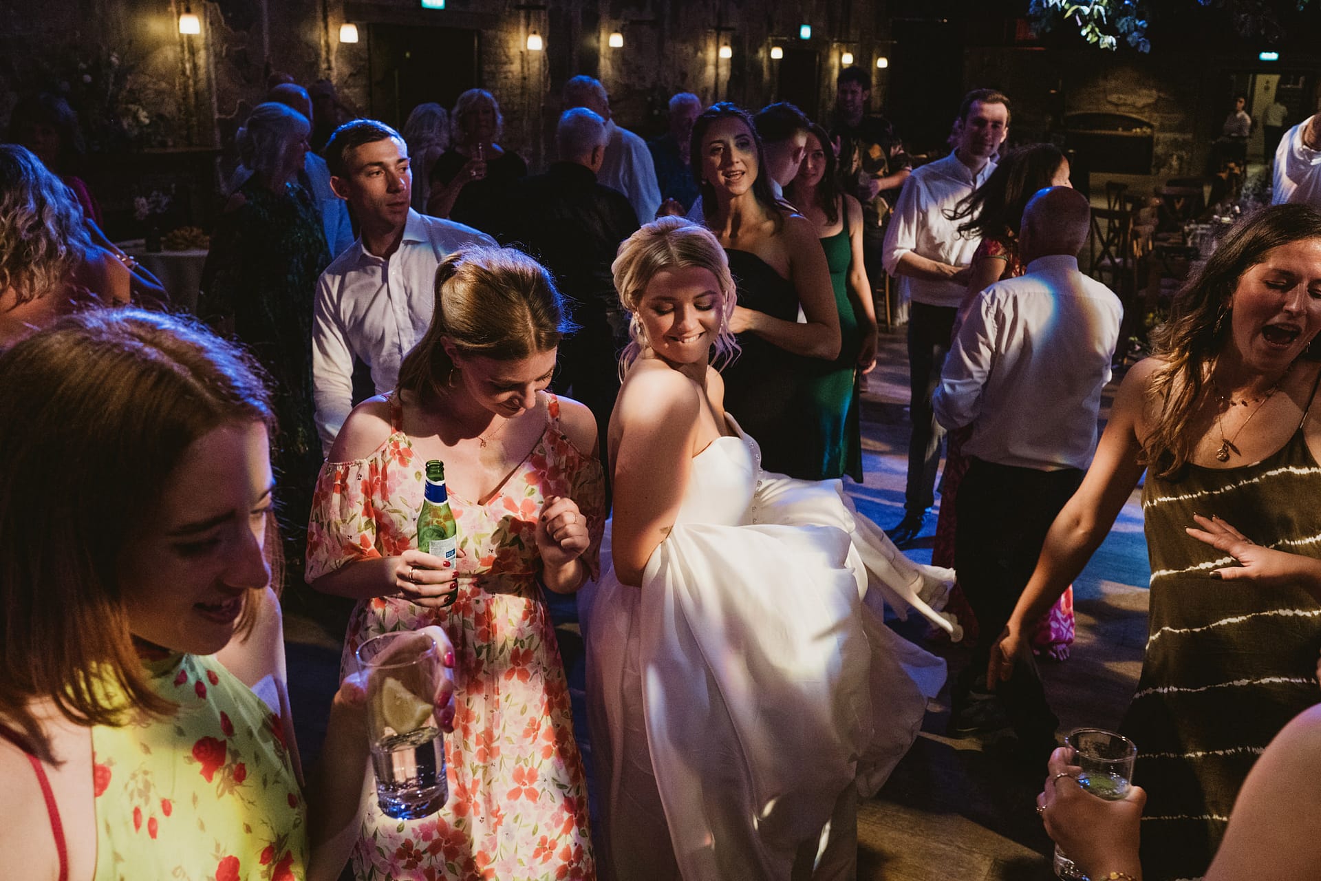 People dancing at a lively wedding reception.