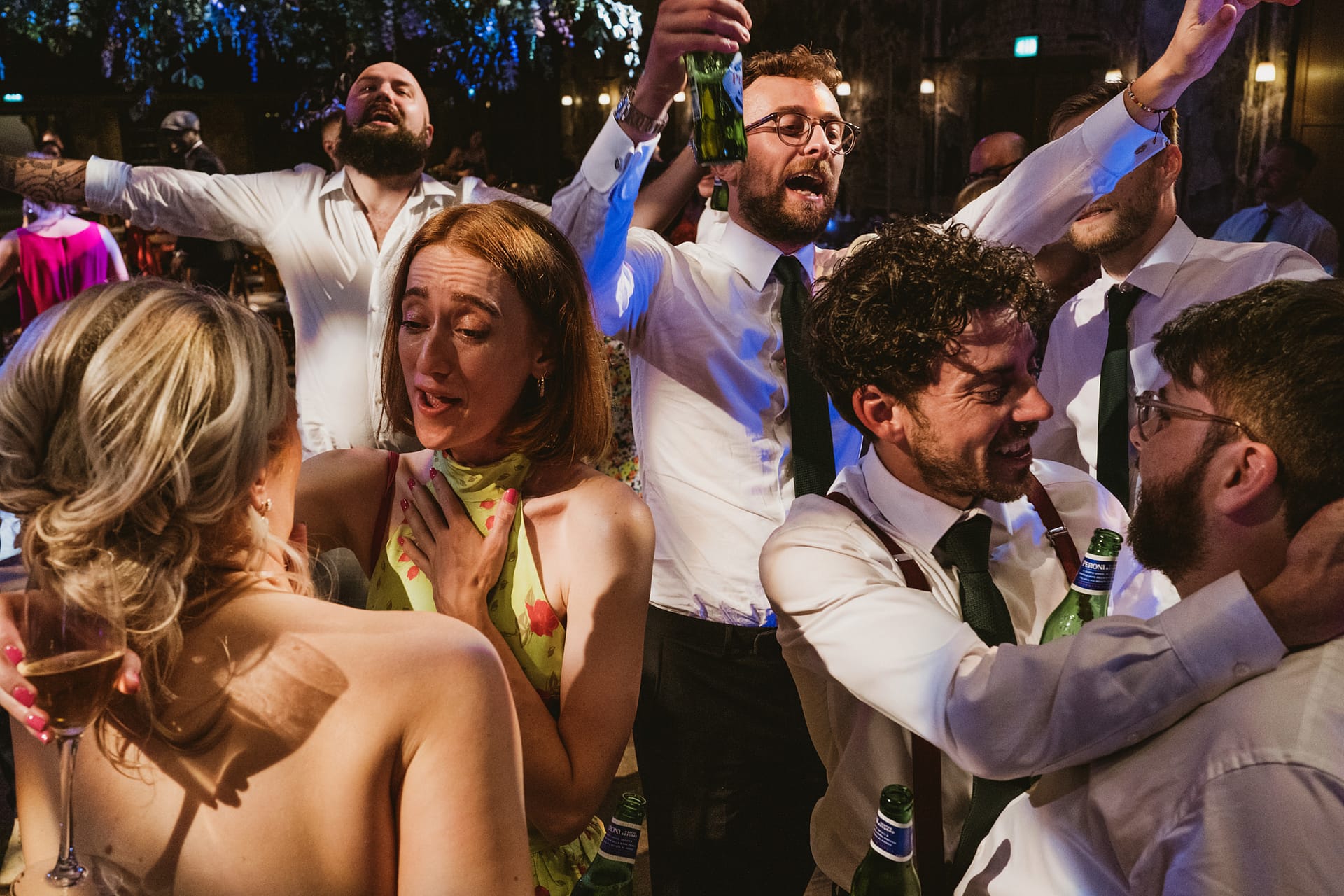 Group celebrating with drinks at a lively party.