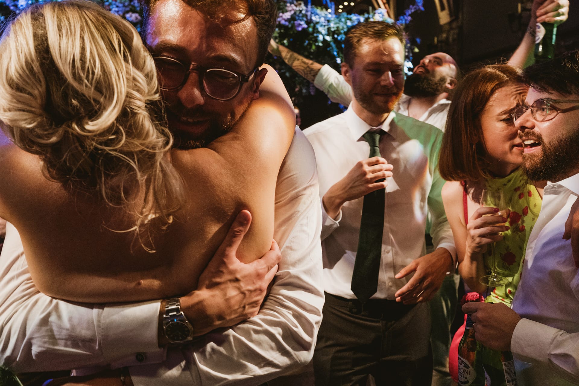 People celebrating and hugging at a party.