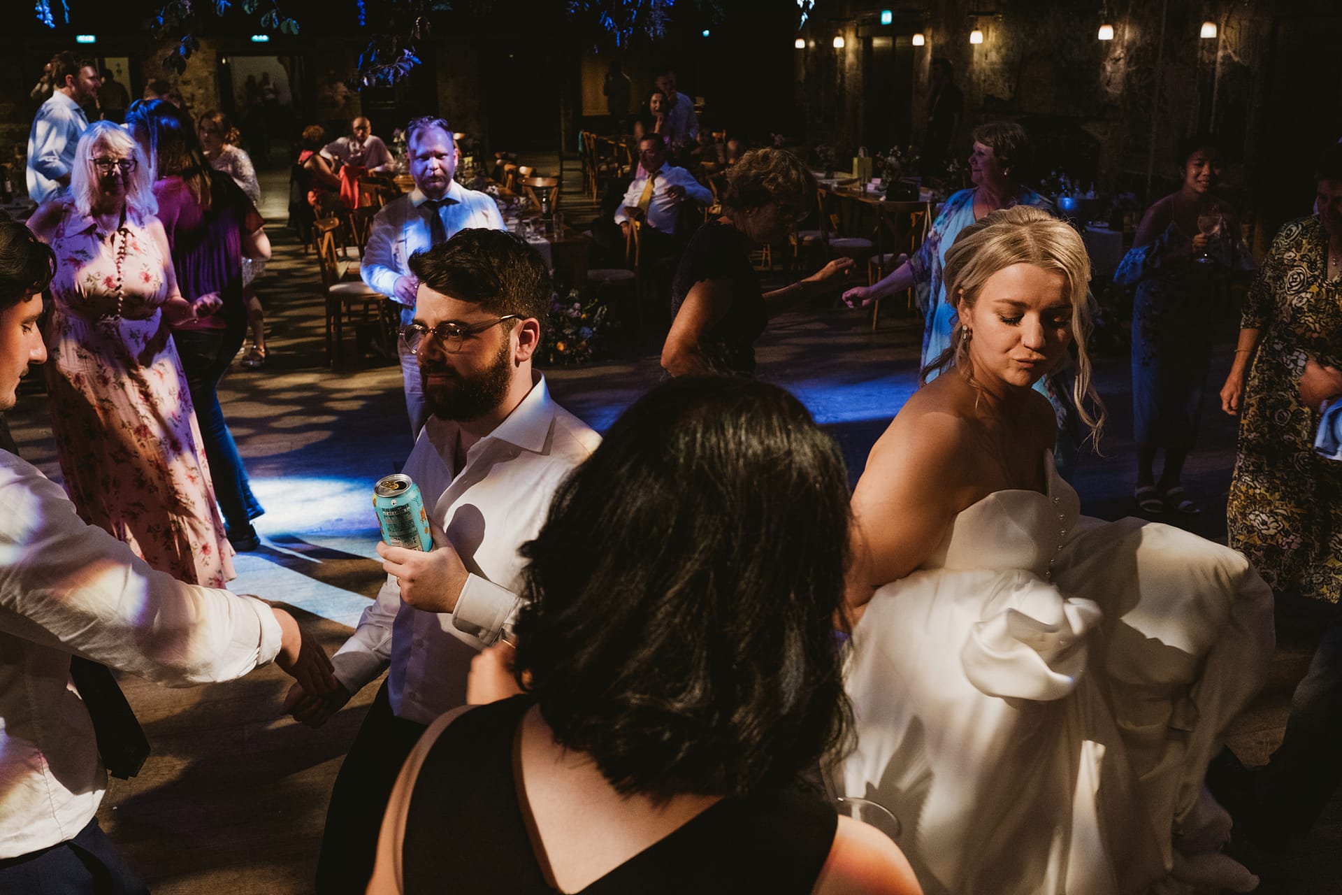 People celebrating and dancing at wedding reception party.