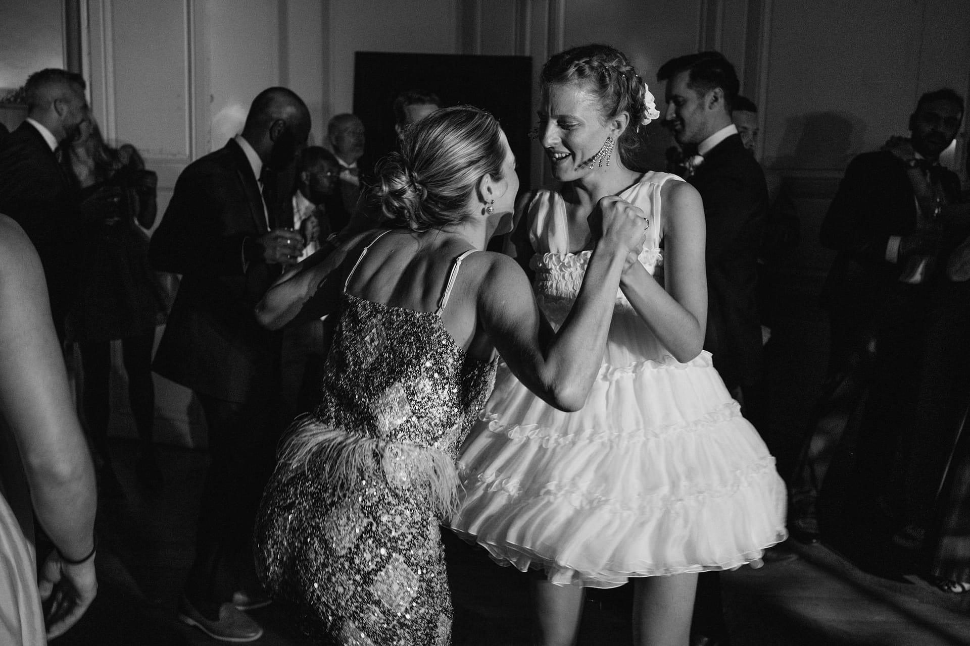 Chateau du Fey wedding images. A black and white photo of the bride and sister dancing together