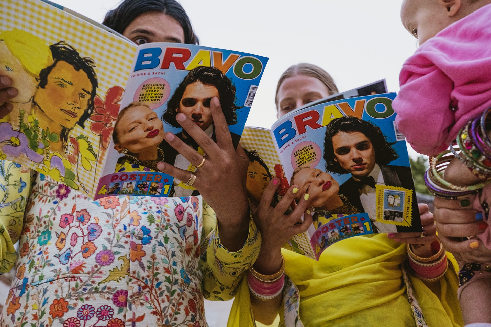 The bride and groom looking at their magazines with their faces on them at Chateau du Fey in France