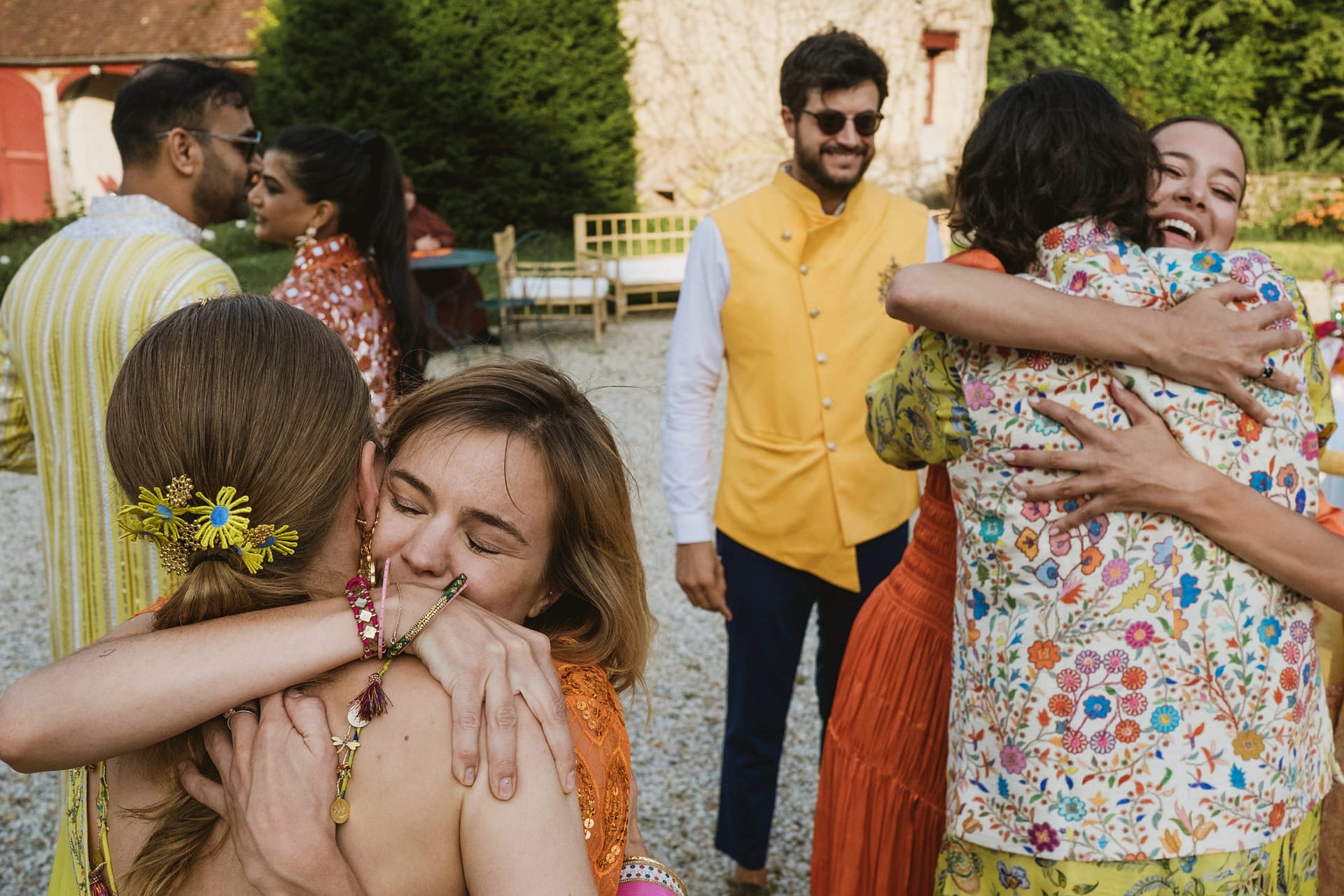 Wedding guests hugging at the Burgundy region of France at the Chateau du Fey