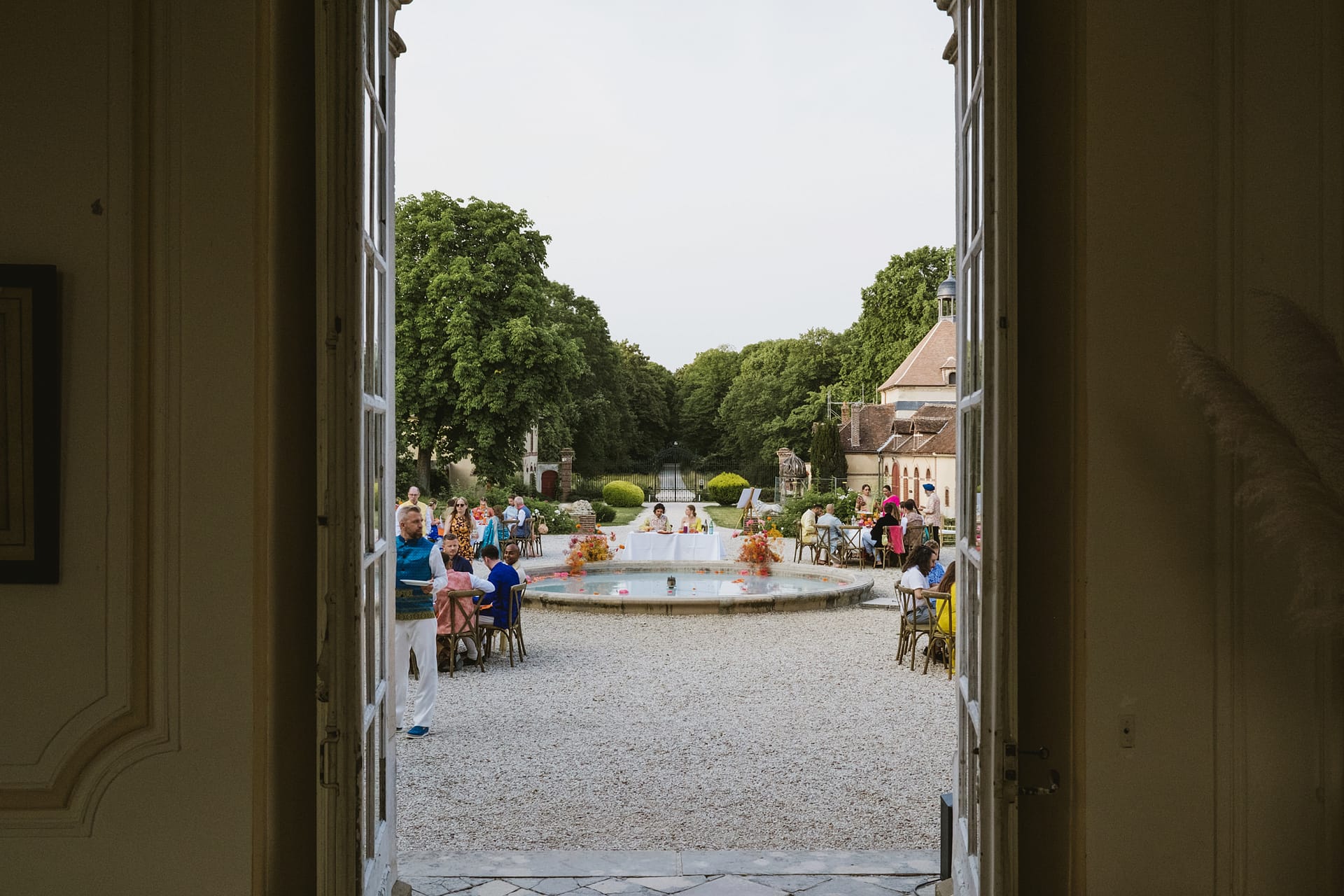 A shot through the door of the Chateau du Fey with the bride and groom framed in the middle.