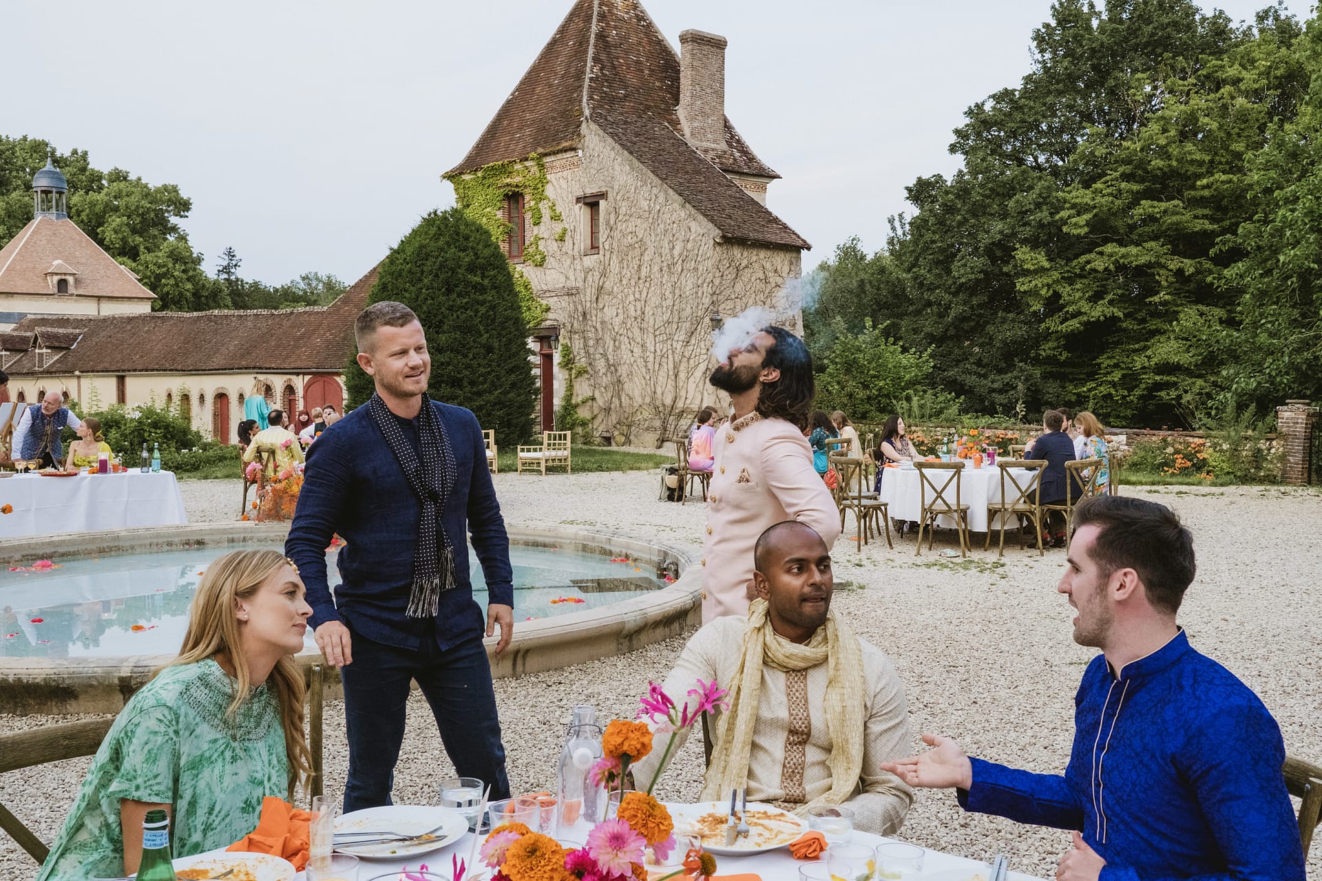 wedding guests drinking and smoking at Chateau du Fey in France