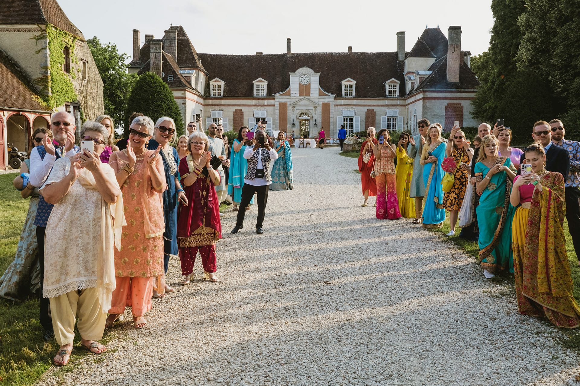 the wedding guests arrive for the entrance of the bride and groom at Chateau du Fey in France