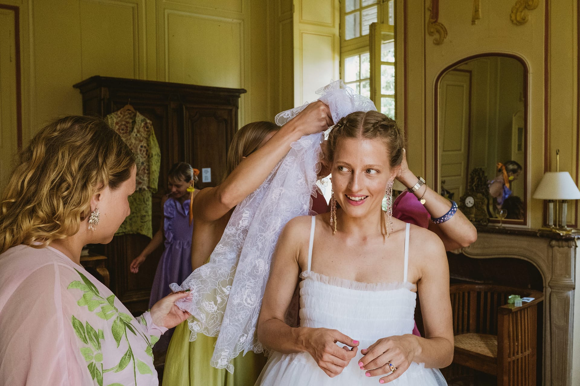 the bride having her veil put on at Chateau du Fey in France