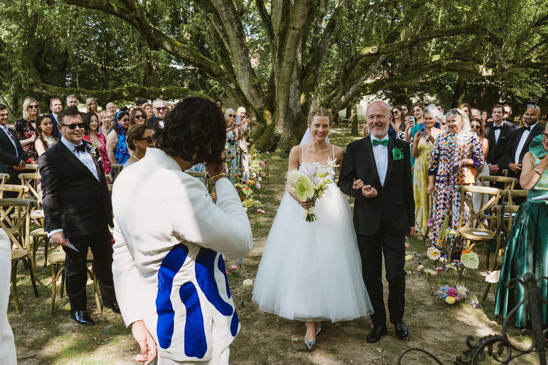 The groom gets emotional seeing the bride for the first time as she walks down the aisle at Chateau du Fey in France