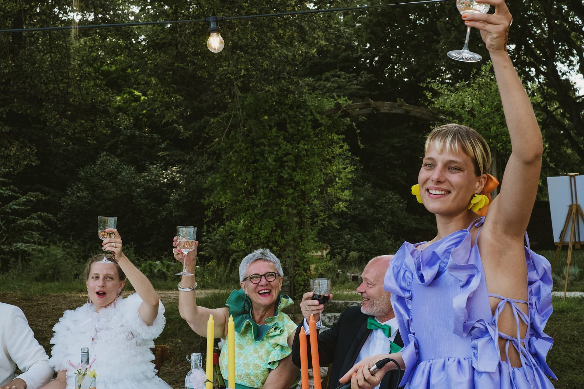 all the wedding guests and party cheering during the wedding speeches at Chateau du Fey in France