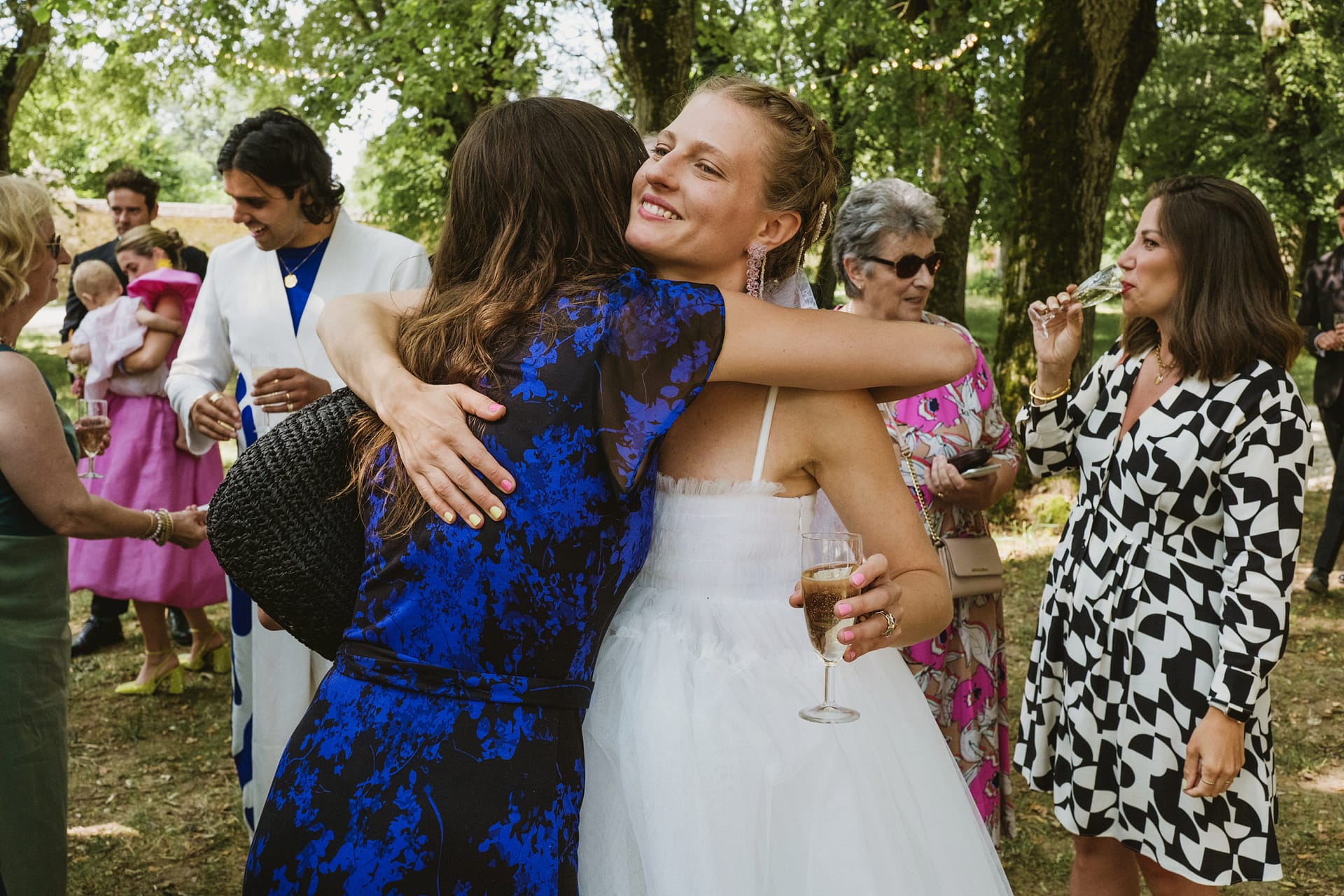 bride hugs wedding guest at Chateau du Fey in France