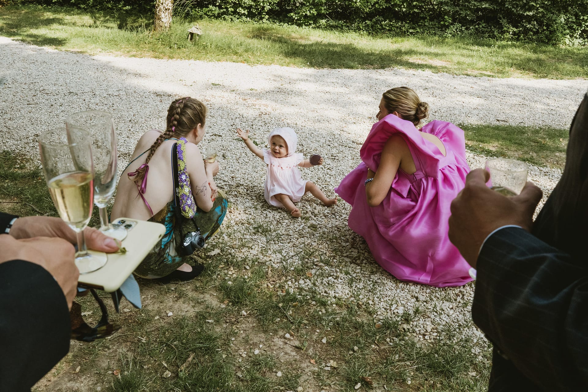 little baby on the ground playing with stones at the Chateau du Fey wedding reception