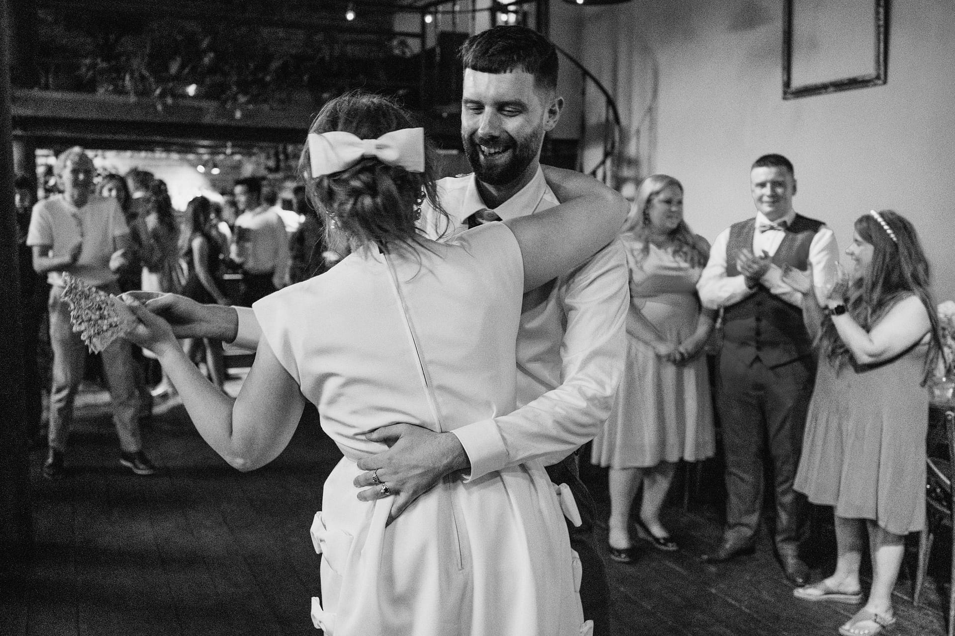 Couple dancing joyfully at their wedding reception.