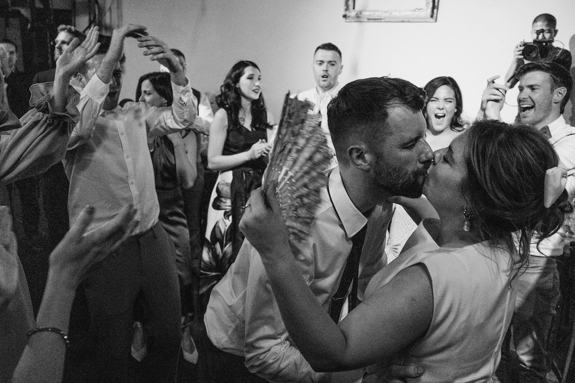 Bride and groom kissing at wedding reception