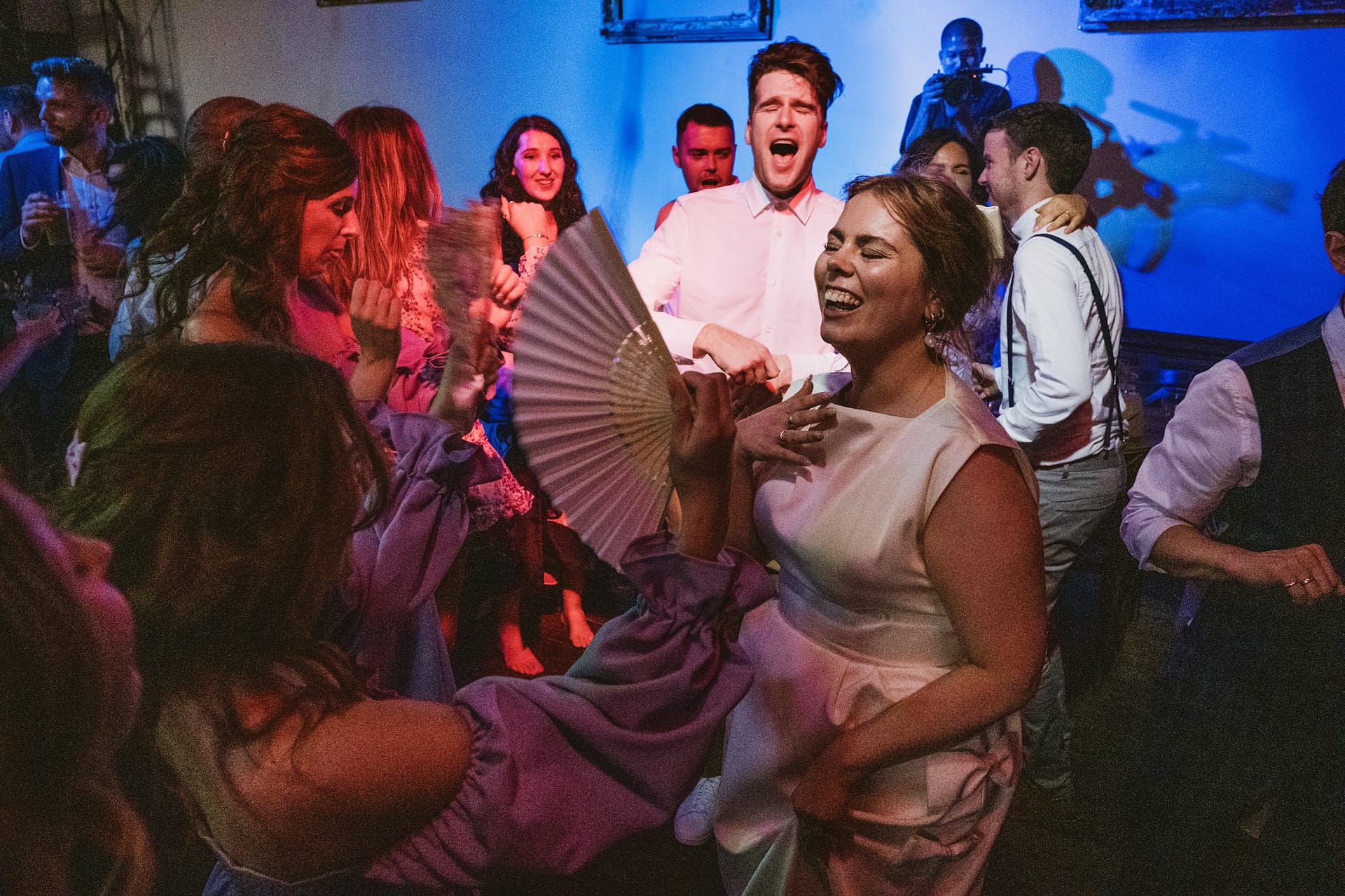 People dancing and laughing at a party.