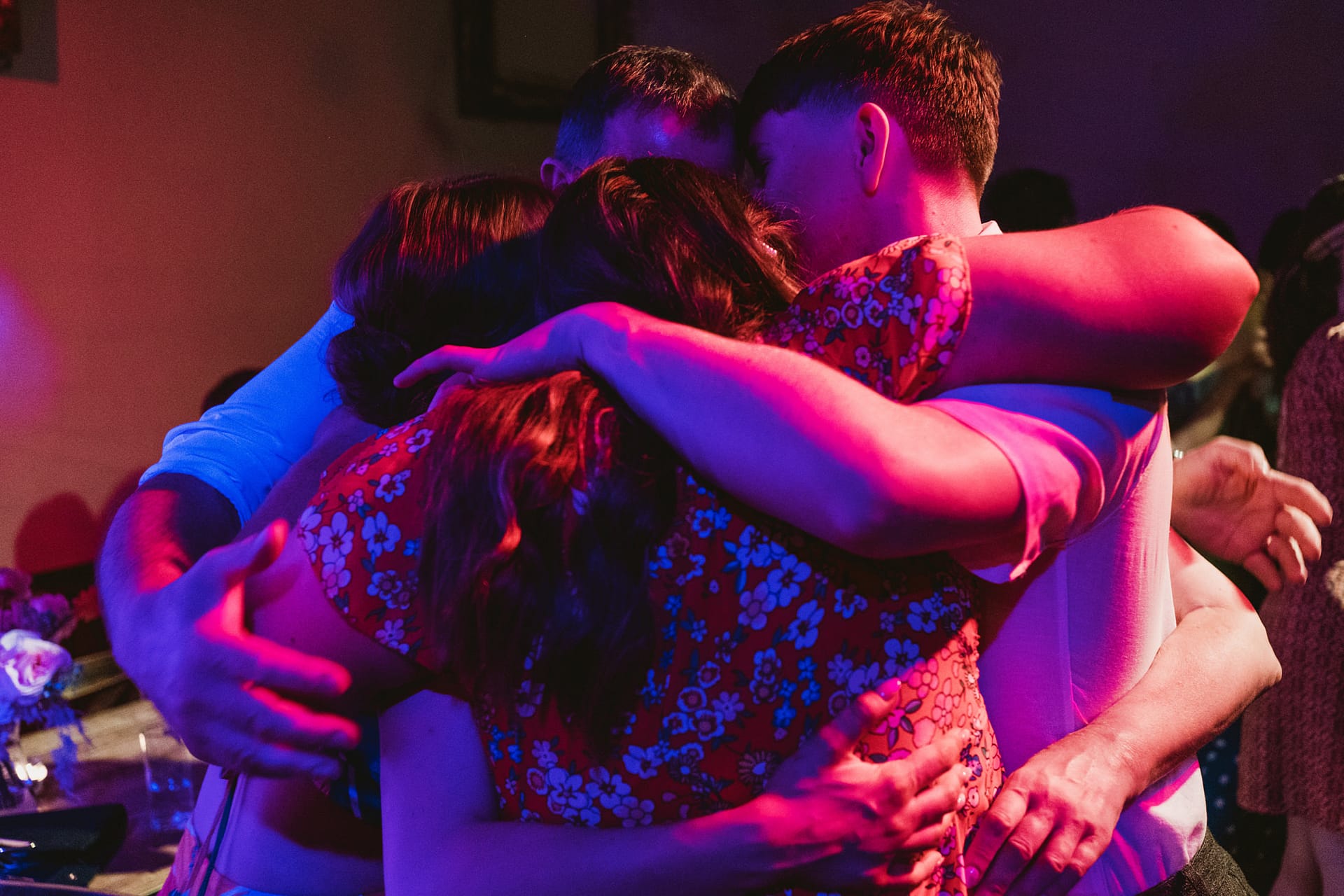 Group hug in colourful lighting