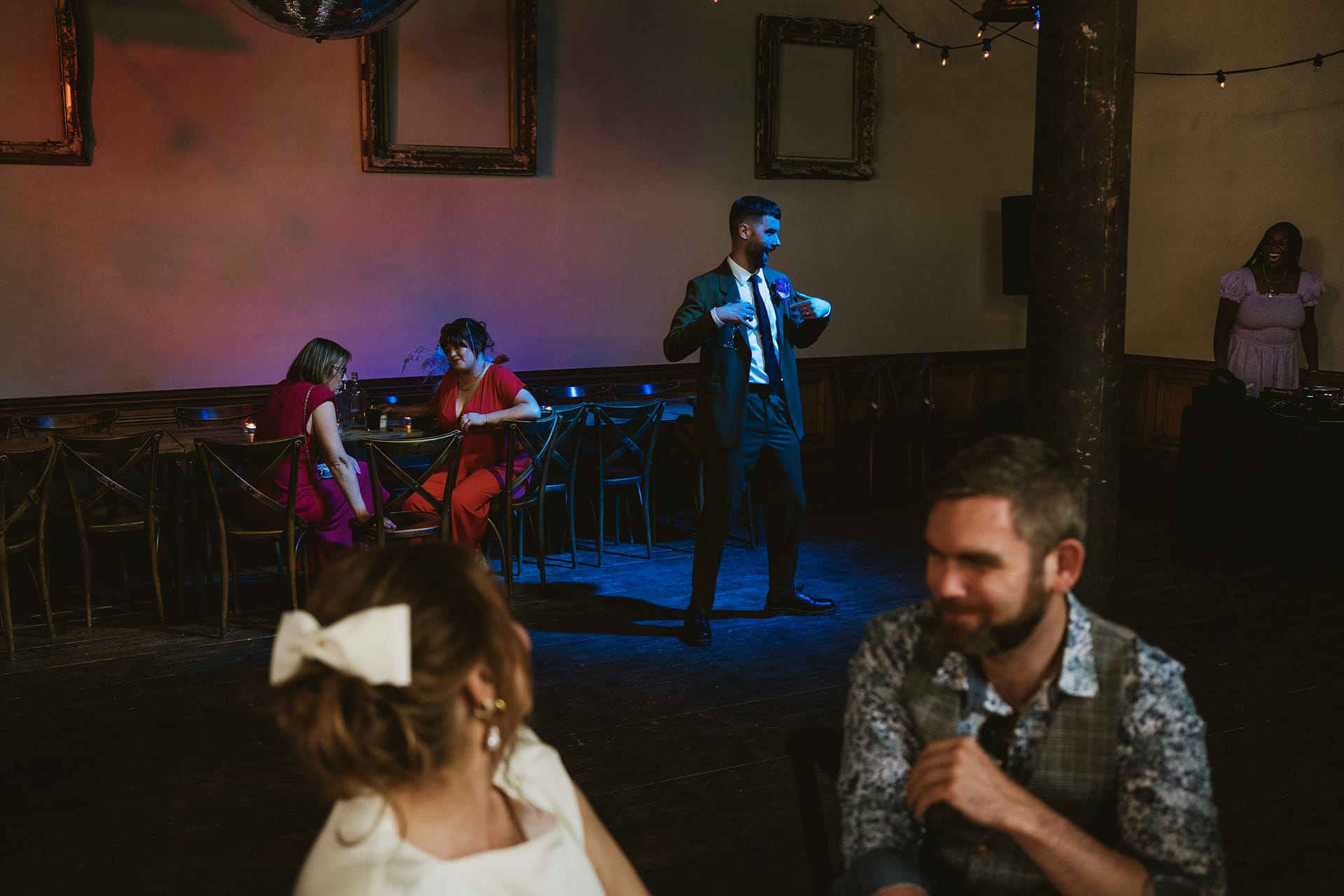 People socialising and dancing at an event.