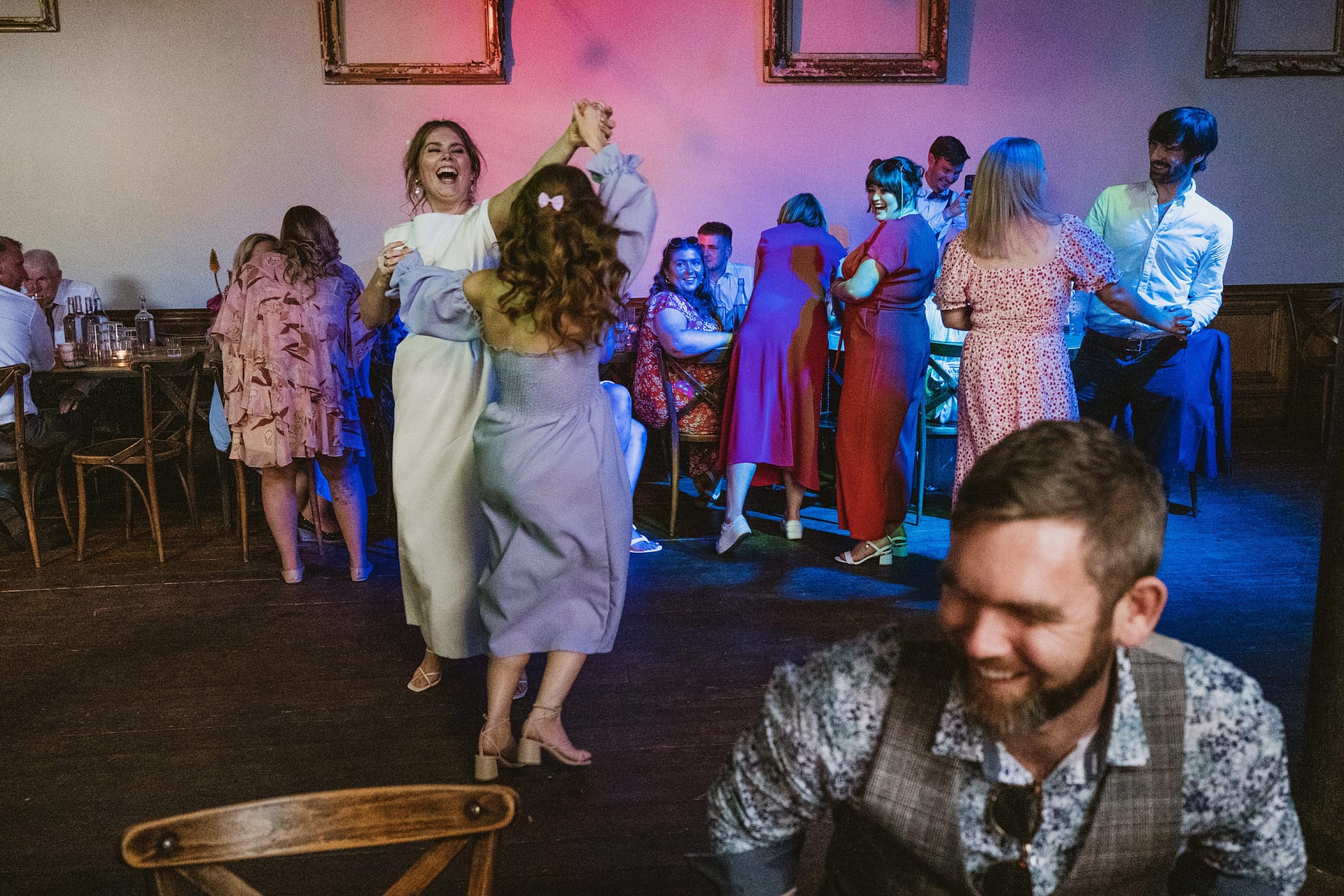 People dancing and socialising at a lively party.