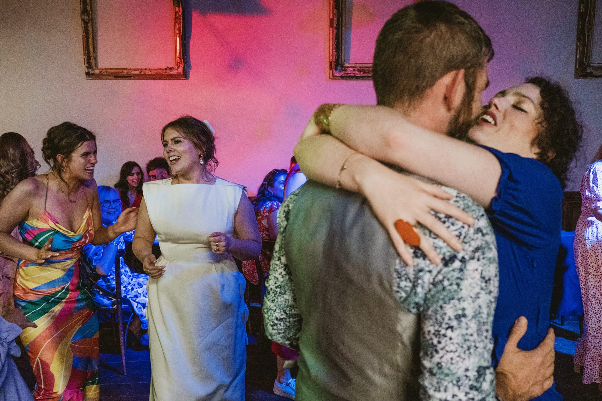 People dancing and celebrating at a wedding reception.