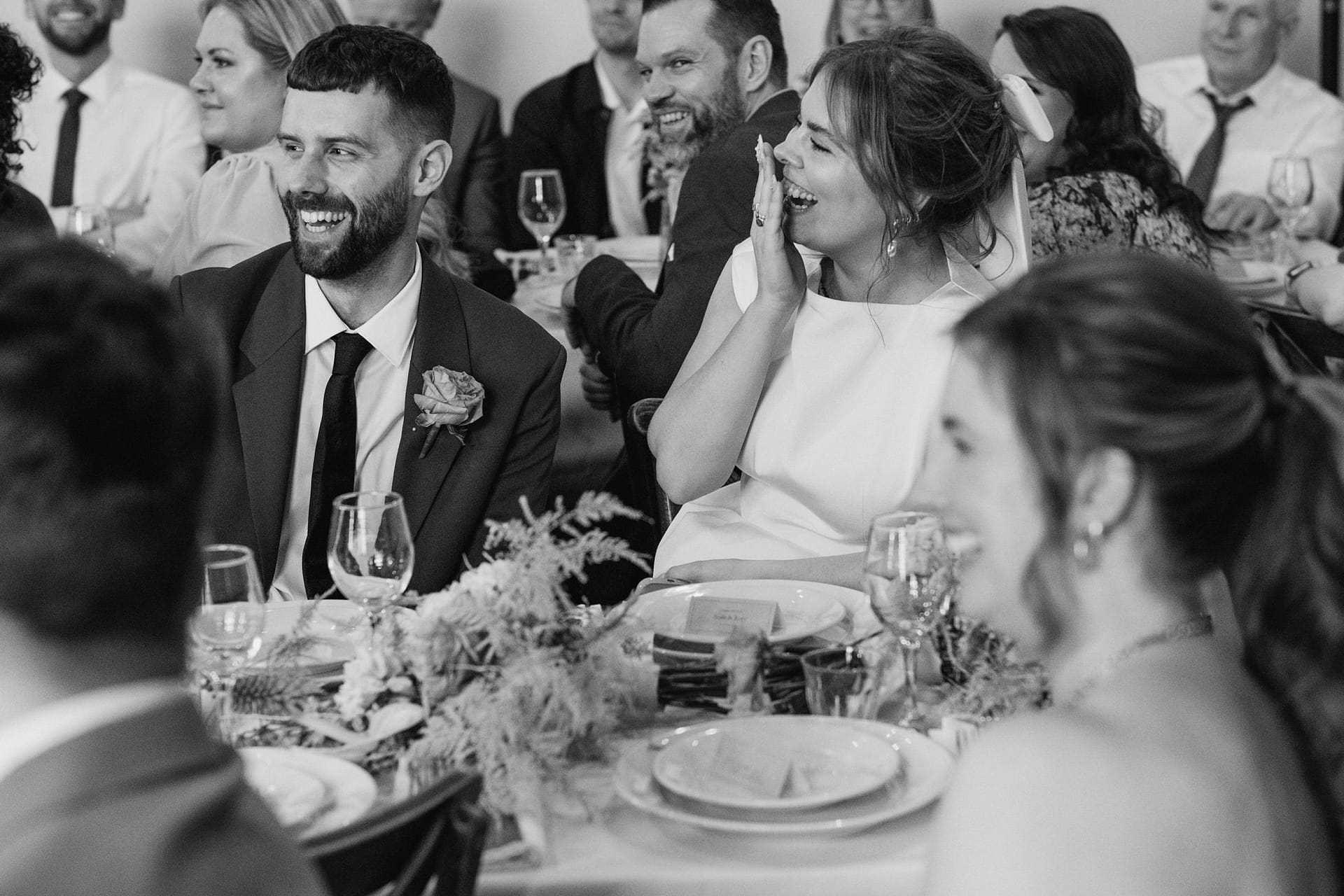 Laughing guests at a wedding reception.